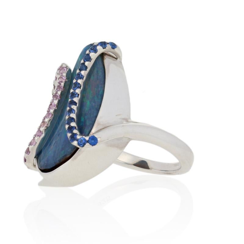 This ring is a size 6.

Metal Content: Guaranteed Sterling Silver as stamped

Stone Information: 
Genuine Boulder Opal

Genuine Sapphires
Treatment: Heating  
Colors: Pink & Blue  
Cut: Round
Pink Sapphires' Carats: 0.34ctw 
Blue Sapphires' Carats: