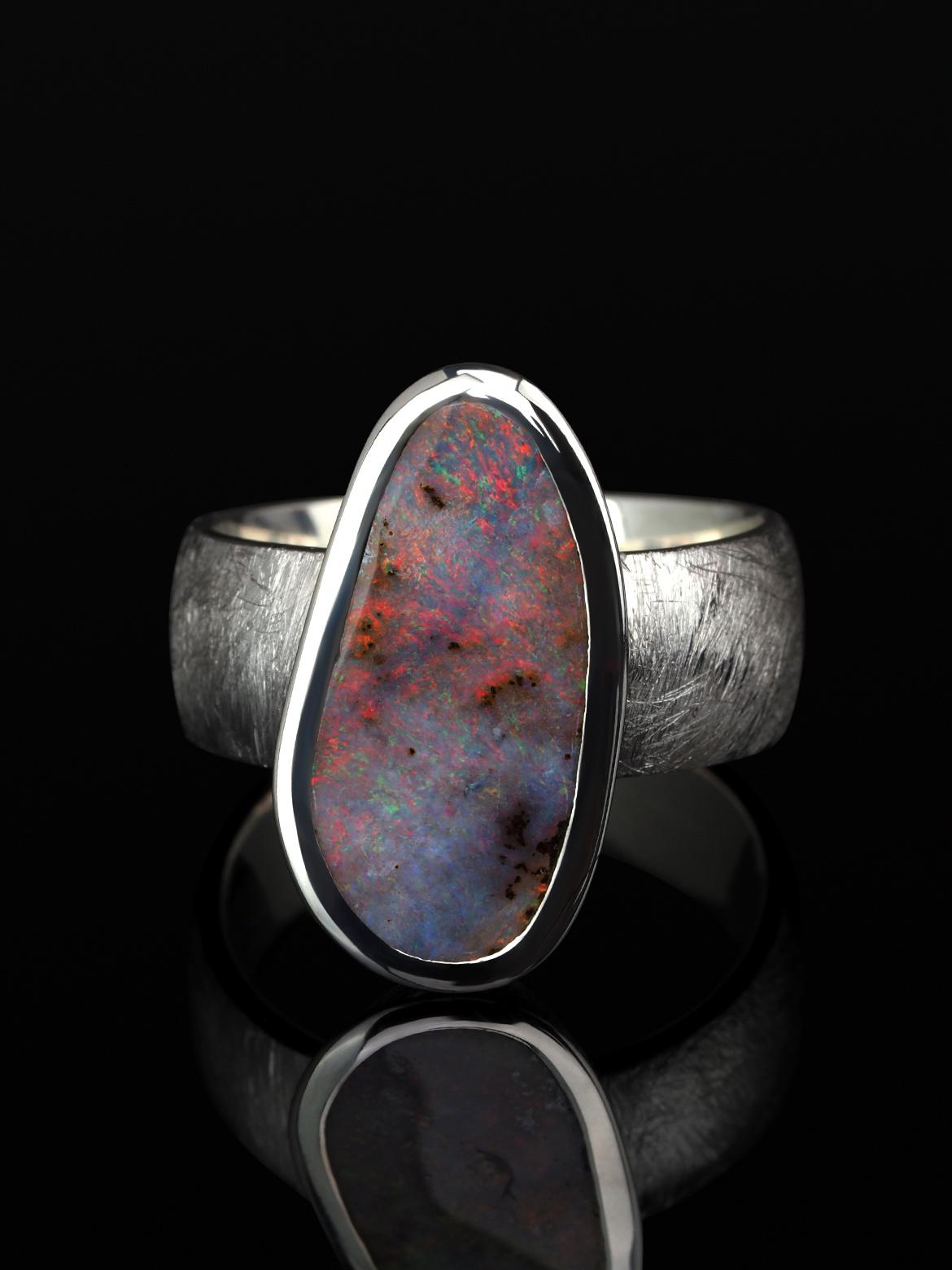 Scratched silver ring with natural Boulder Opal
opal origin - Australia
stone measurements - 0.16 x 0.35 x 0.75 in /  4 х 9 х 19 mm
opal weight - 3.09 carats
ring size - 7.5 US
ring weight - 7.96 grams
