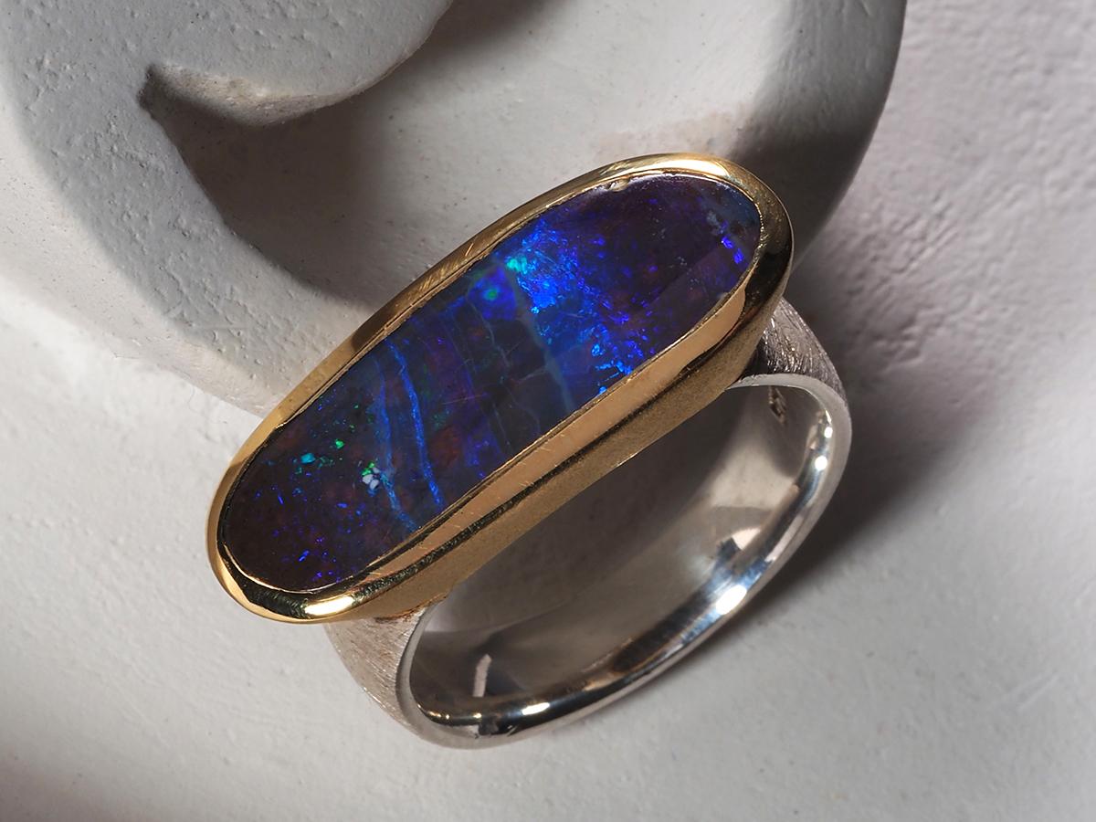 Scratched gold plated silver ring with natural Boulder Opal
opal origin - Australia
opal measurements - 0.35 х 0.94 in / 9 х 24 mm
stone weight - 5 carats
ring weight - 10.14 grams
ring size - 19 RU / 9 US
