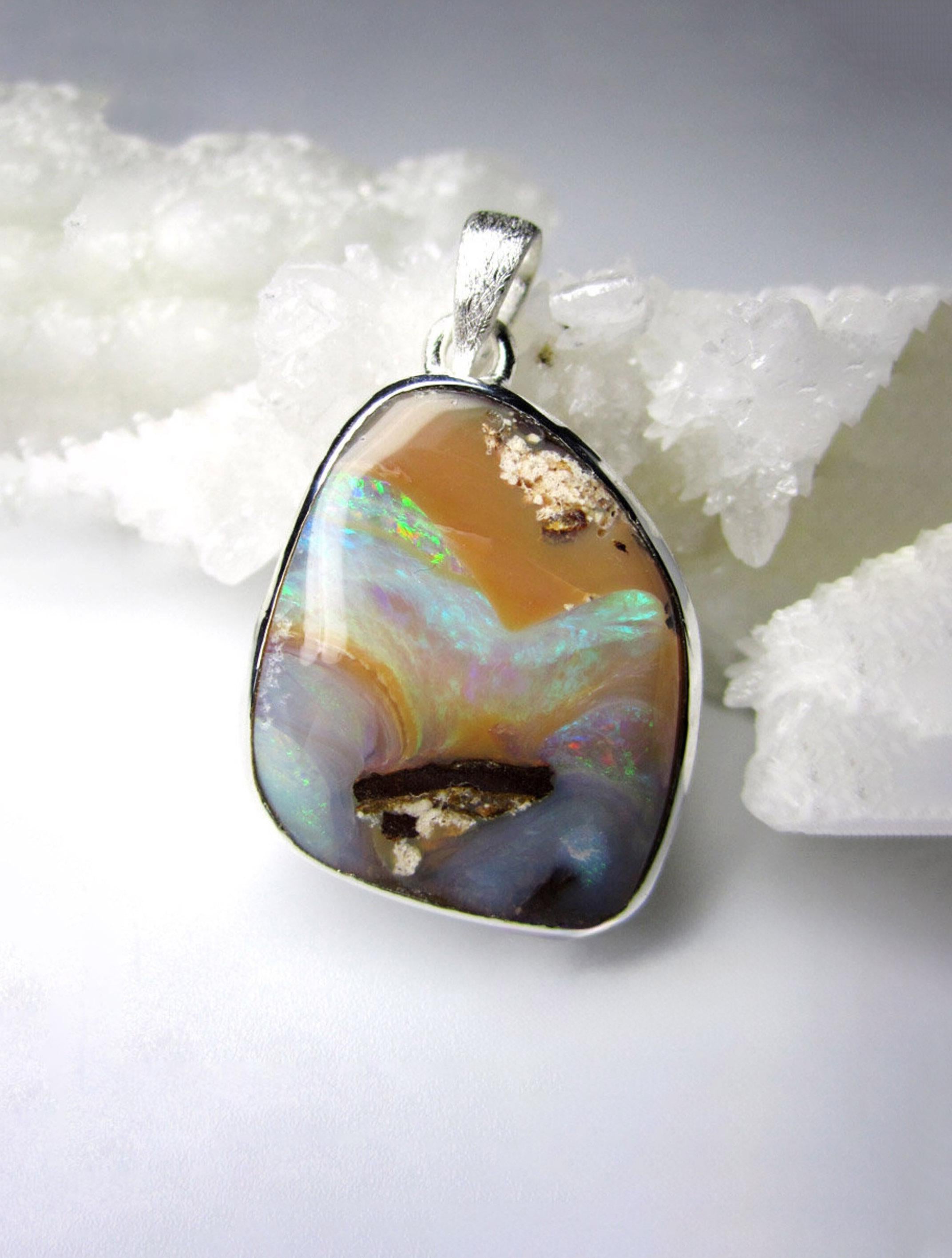 Scratched silver pendant with natural Boulder Opal 
gemstone origin - Australia
gem size - 0.35 х 0.79 х 0.94 in / 9 х 20 х 24 mm
gem weight - 33.5 carats
pendant length - 1.42 in / 36 mm
pendant  weight - 10.57 grams