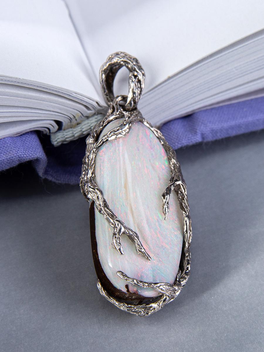 Silver pendant with natural Boulder Opal
opal origin - Australia 
opal measurements - 0.2 х 0.51 х 1.06 in / 5 х 13 х 27 mm
opal weight - 19.45 carats
pendant weight - 6.54 grams
pendant height - 1.61 in / 41 mm

Roots collection