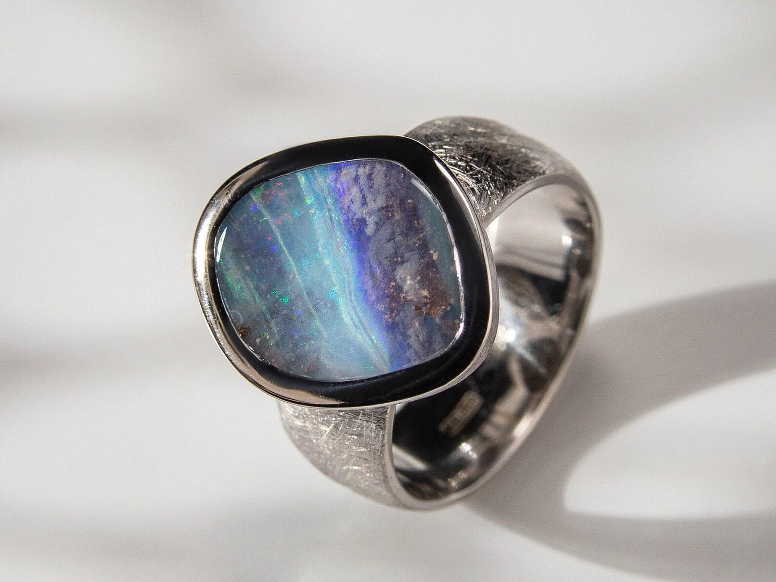 Matte finish silver ring with natural Boulder Opal 
gemstone origin - Australia
gem size is 0.12 x 0.47 x 0.59 in / 3 х 12 х 15 mm
opal weight - 6.20 carats
ring size - 8 1/4 US
ring weight - 8.5 grams