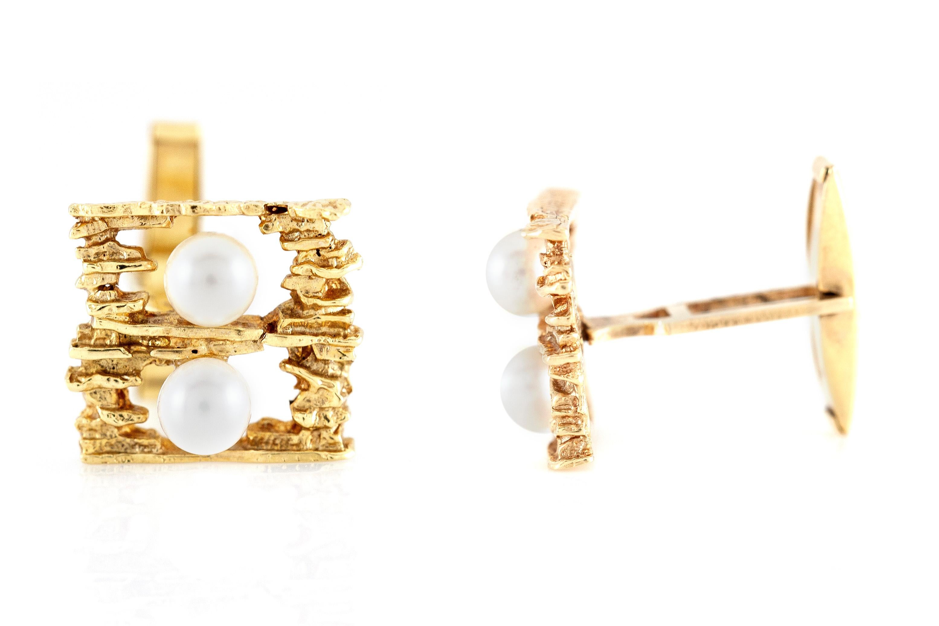Cufflinks finely crafted in 14k yellow gold with two pearls on each piece, size of each cufflink is 0.80 inch. Circa 1920.