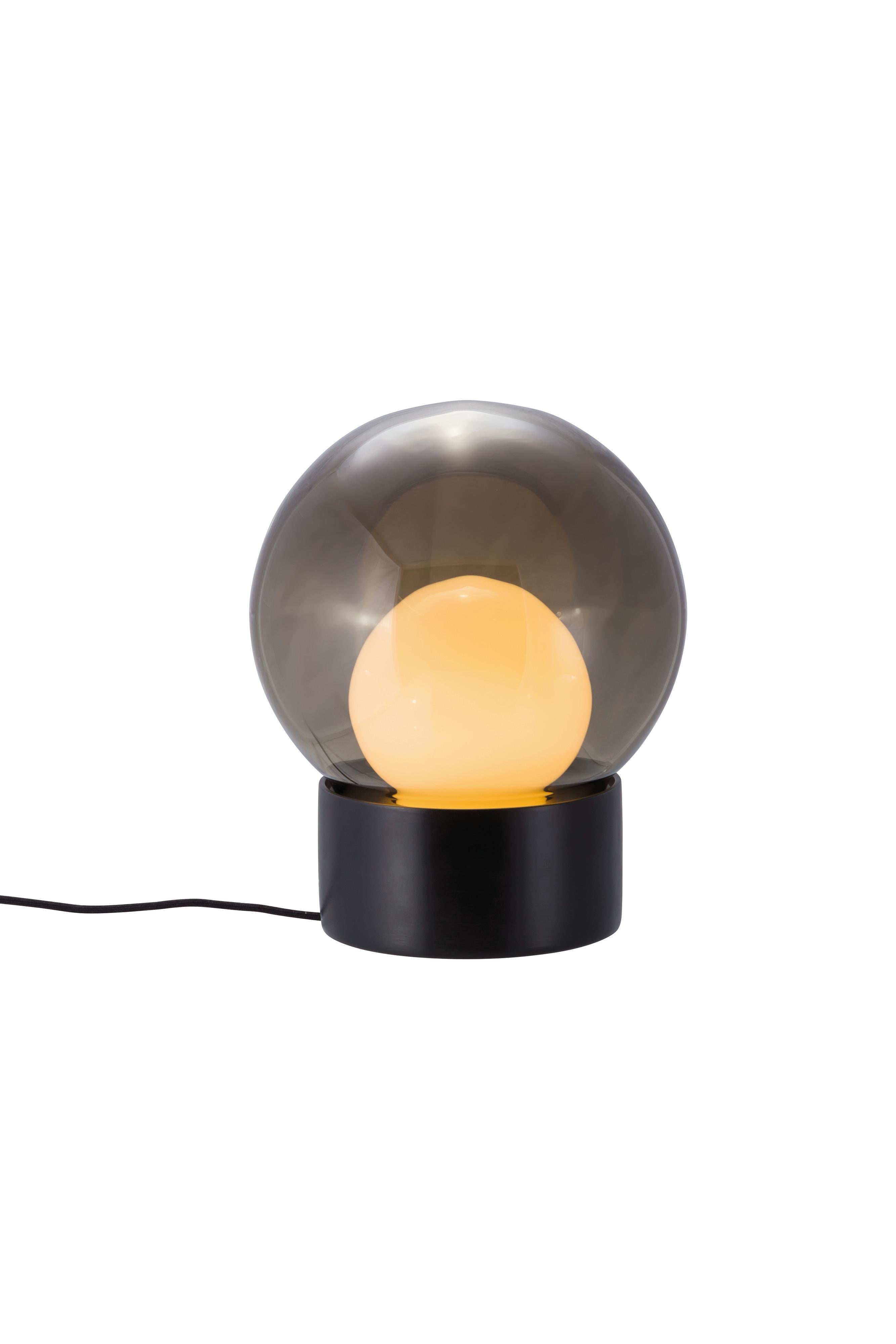 Boule small smoky grey opal white black table lamp by Pulpo
Dimensions: D29 x H35.5 cm
Materials: ceramic, handblown glass, coloured, textile.

Also available in different finishes: transparent opal white black, transparent smoky grey black,