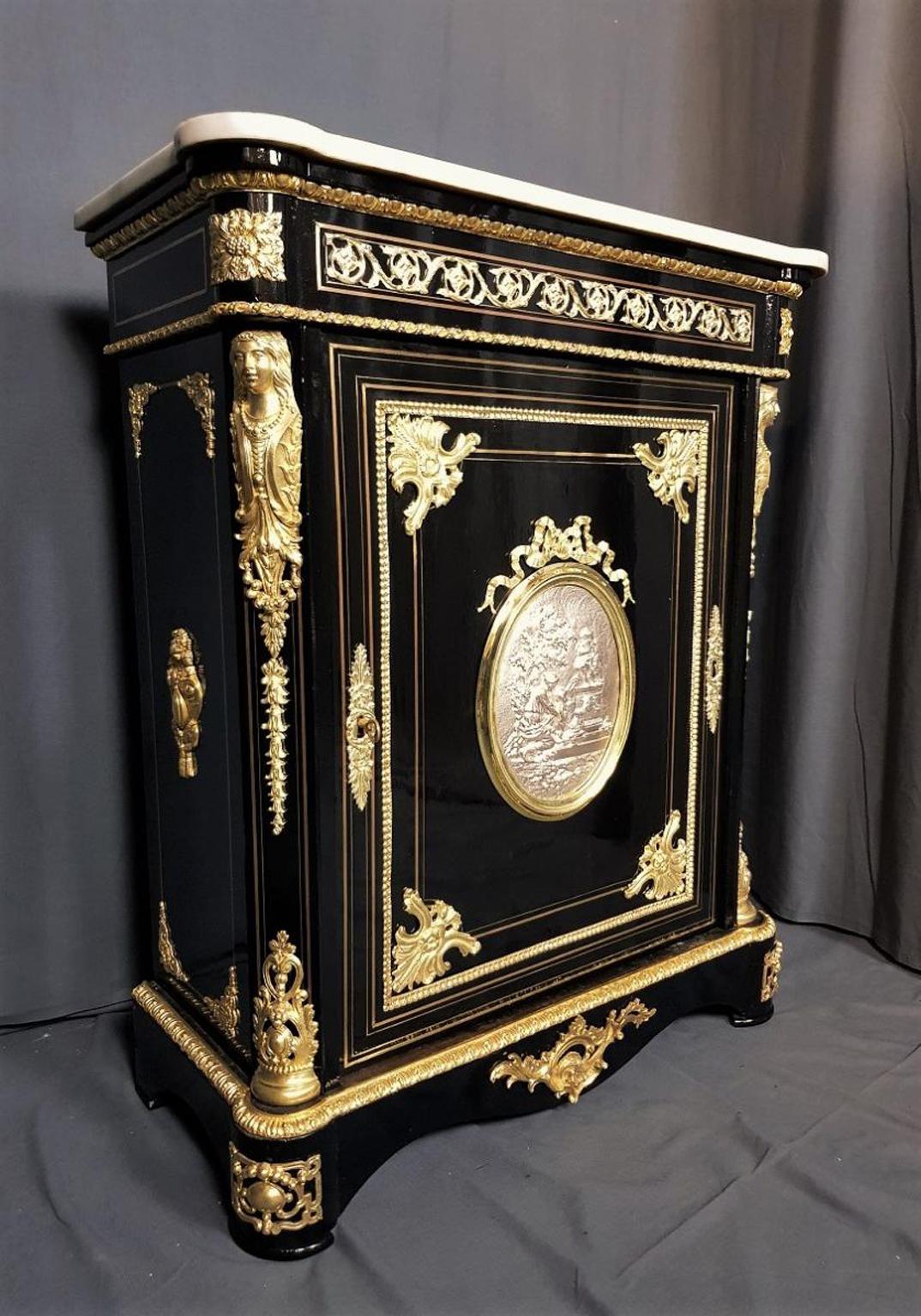 Napoleon IIII cabinet in Boulle marquetry style in brass and a central medallion tow-colored in silver and a delicate bronze ribbon frame around it. Beautifully decorated with important gilt bronze ornamentations such as spandrels and caryatids. The