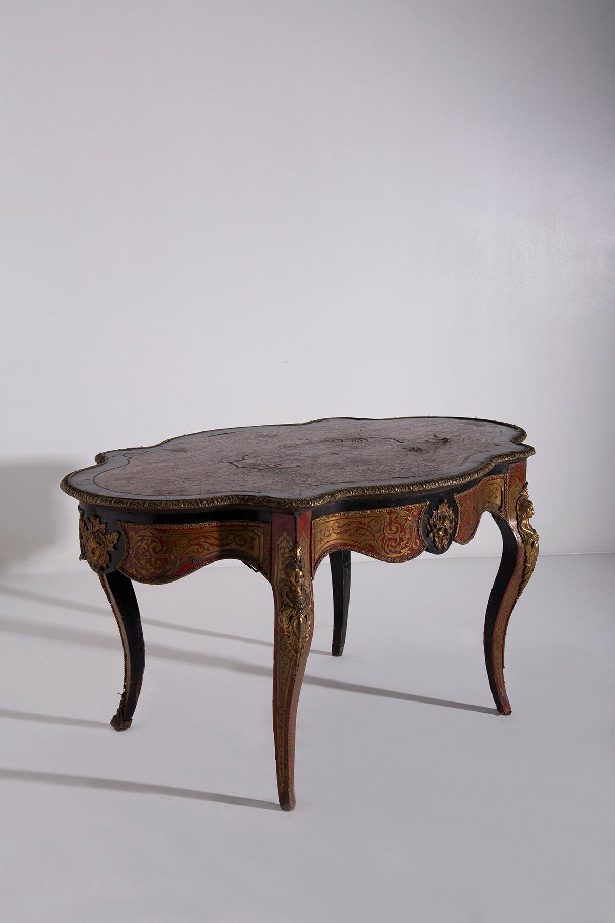 Behold the exquisite beauty of an antique Boulle-style desk from the late 1800s, a true masterpiece that once graced the era of Napoleon III. This desk is not just a piece of furniture; it is a work of art that takes you on a journey through time,