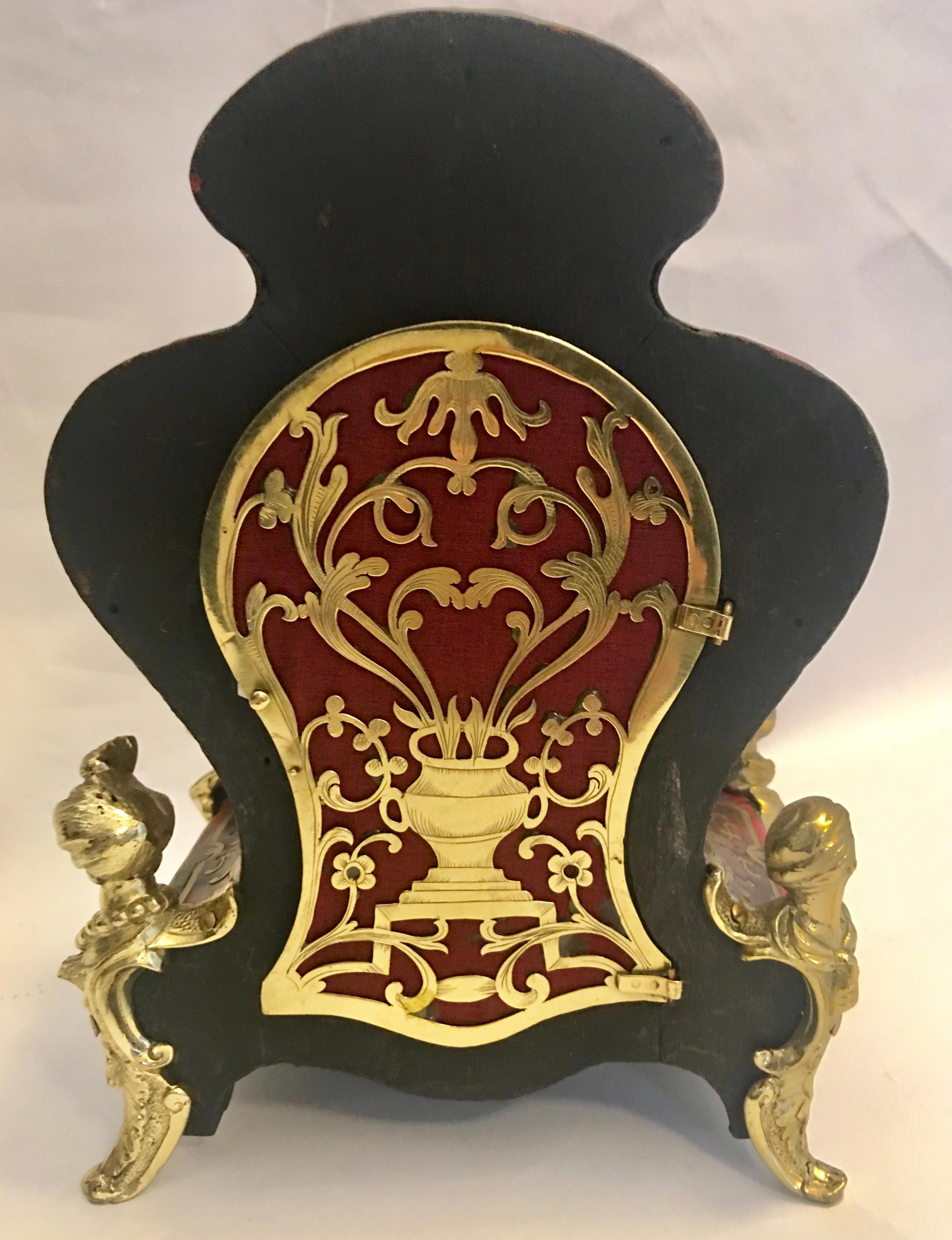 A beautiful and rare gilt brass-mounted boulle mantel timepiece
Second quarter of the 18th century

The case of shaped outline, inlaid with cut brass and tortoiseshell, with pierced and engraved hinged back door, the 3in. gilt engraved dial with