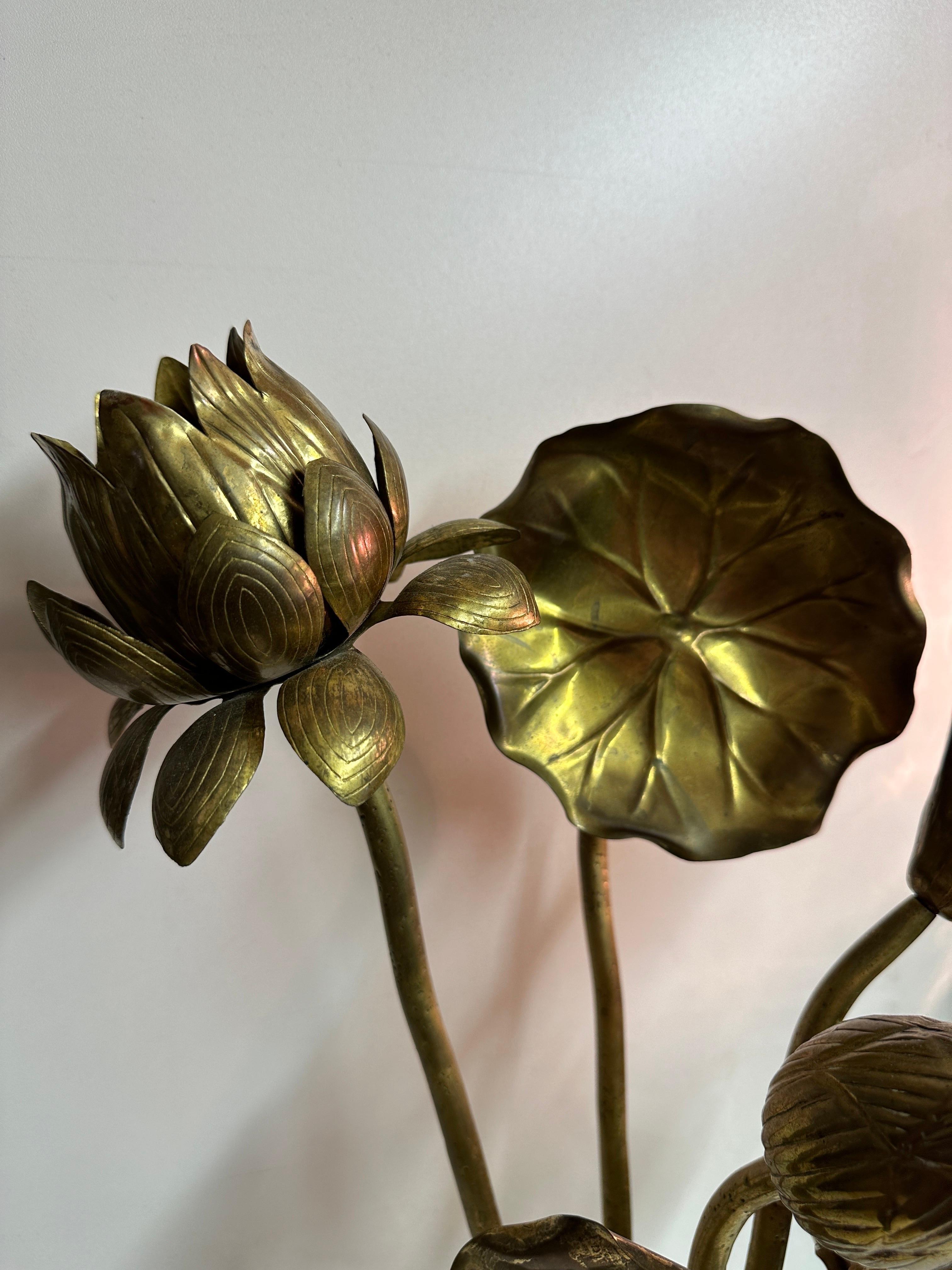 Set of six bouquet of Feldman brass lotus flowers in all original patina. Glass vase shown is not included. Tallest lotus is 24” tall, shortest is 15” tall.