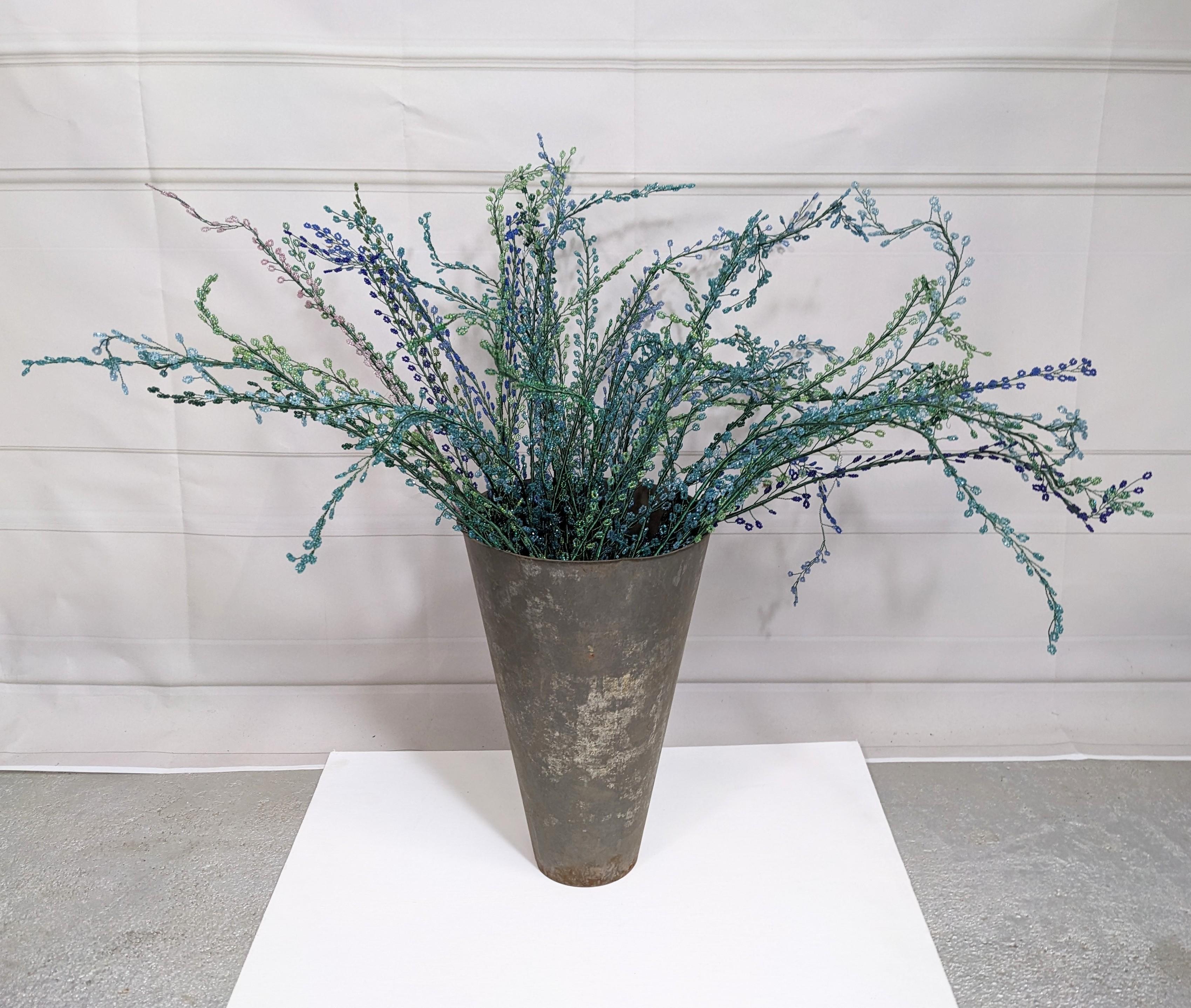 Bouquet of French Hand Beaded Ferns from the 1960's. Dozens of hand wired and beaded ferns in a variety of greens and blues. On strand is a pale pink. Easy to form into different arrangements. A variety of lengths with the longest at 24