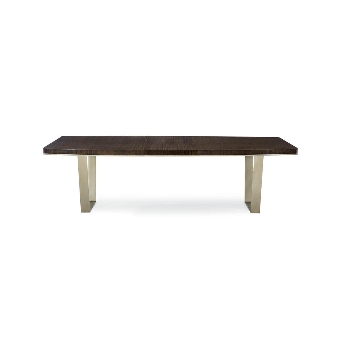 Fumed figured eucalyptus comes to life atop a dining table that is suspended by angled, contemporary metal braces. The wood’s Aged Bourbon finish results in a commanding presence that can be expanded to easily seat 10 people.

The accent molding is