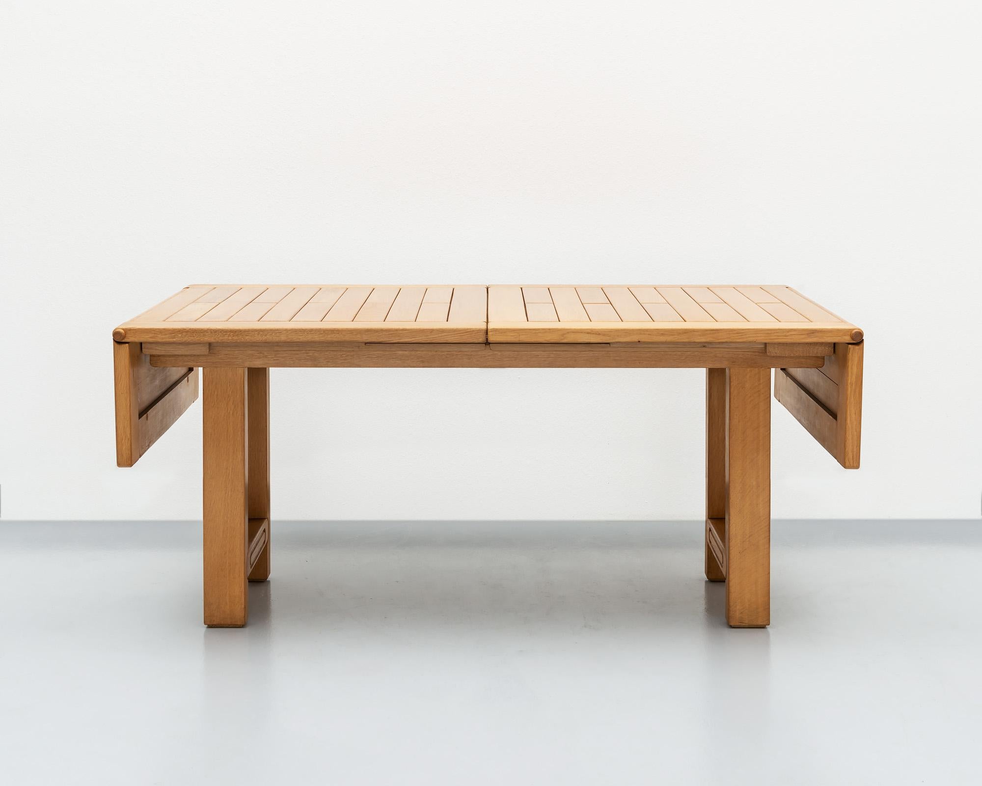 A beautiful example of the work of Guillerme et Chambron in golden oak. This table has drop leaves and comes with one extra leaf (see last two images), which extends the length to 97.5 