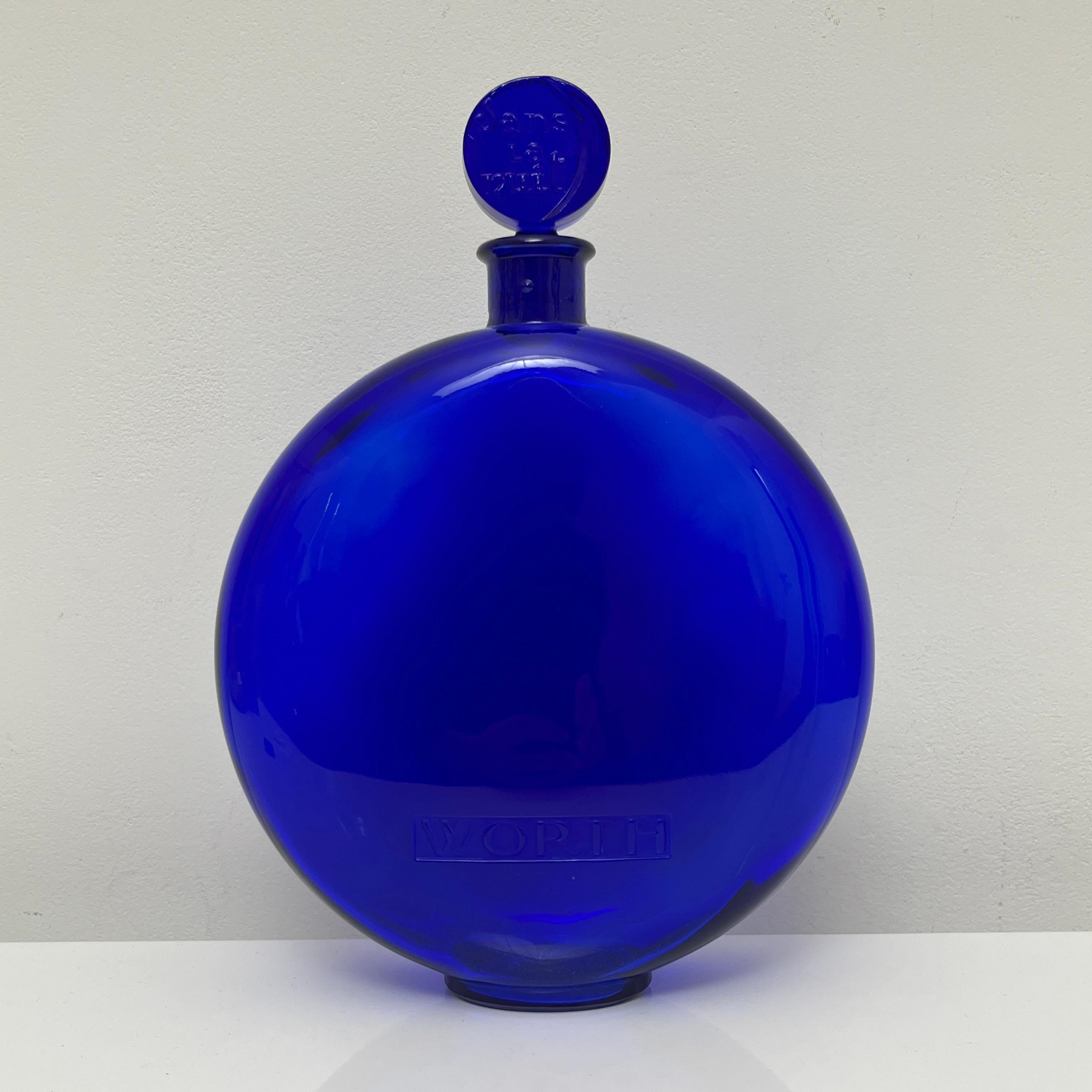 Description : 
•Dans la Nuit de Worth•
Grand flacon lenticulaire en verre bleu cobalt dessiné par Rene Lalique en 1925 pour le parfum dans le nuit de WORTH. Il s'agit de la plus grande version d'un contenance de 1 litre . 

Dimensions : 
Hauteur :
