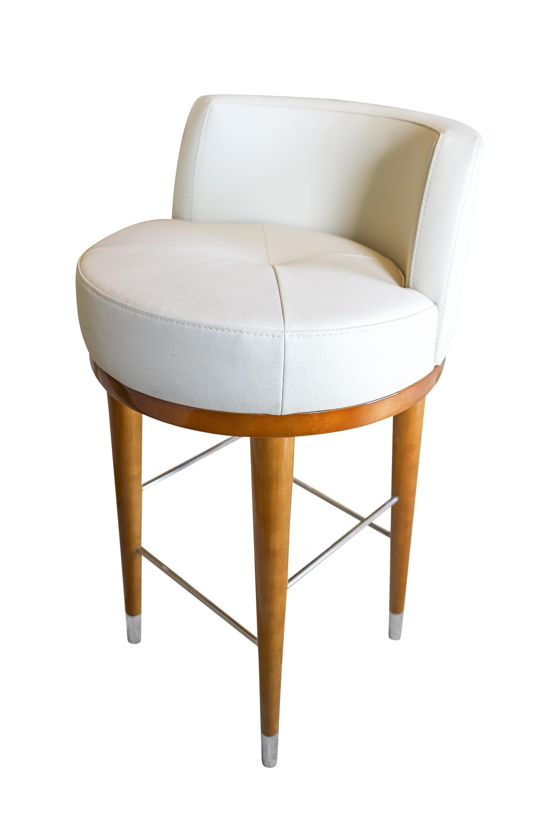 Estos taburetes de bar boutique son de madera lacada con detalles de metal pulido. Disponibles en altura de mostrador y de barra. 