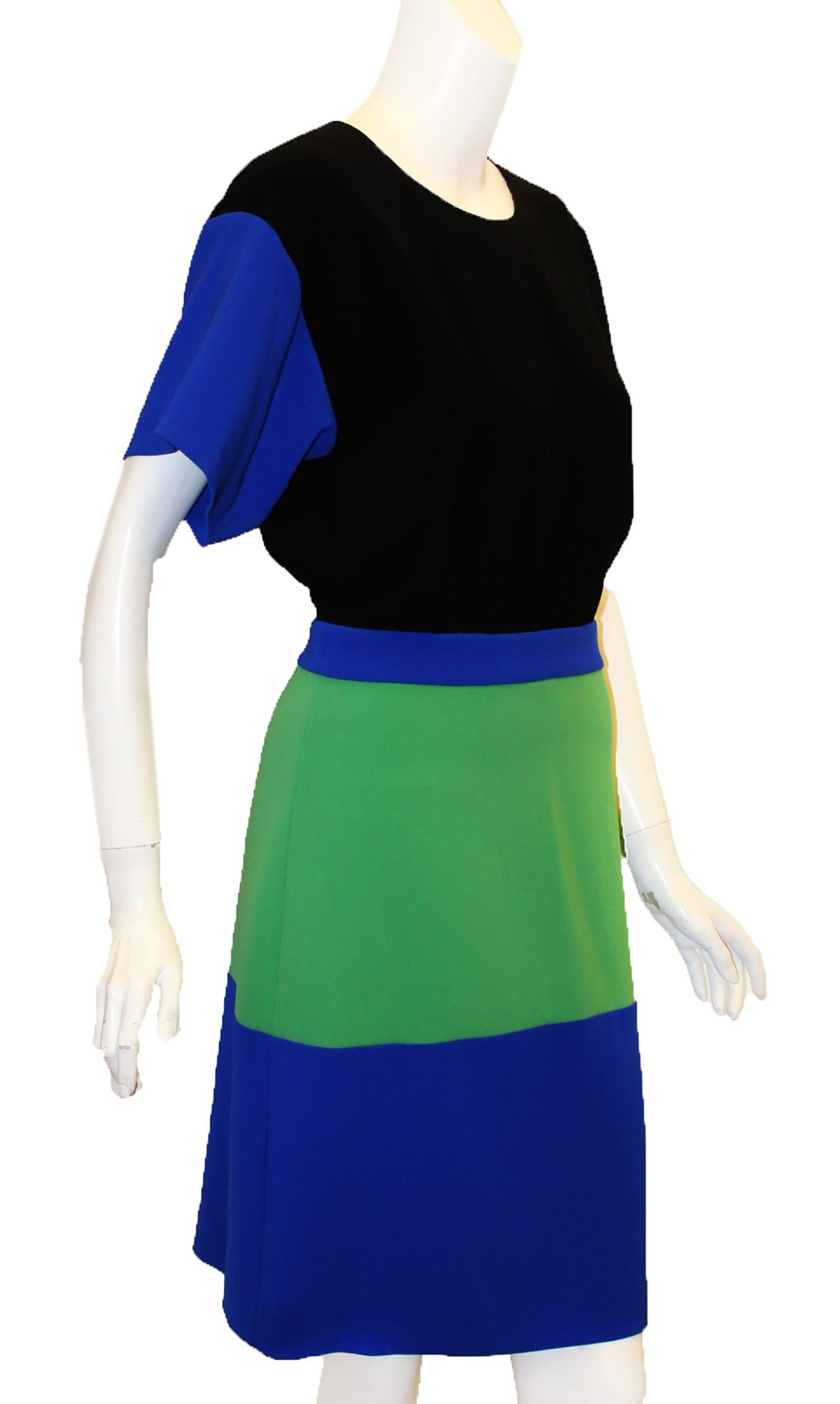Boutique Moschino color block short sleeve dress incorporates royal blue sleeves, waist band and wide hem.  Dress includes black  bodice and wide green band around the hip.  Includes a short back zipper and a side zipper and snaps.  Dress is not