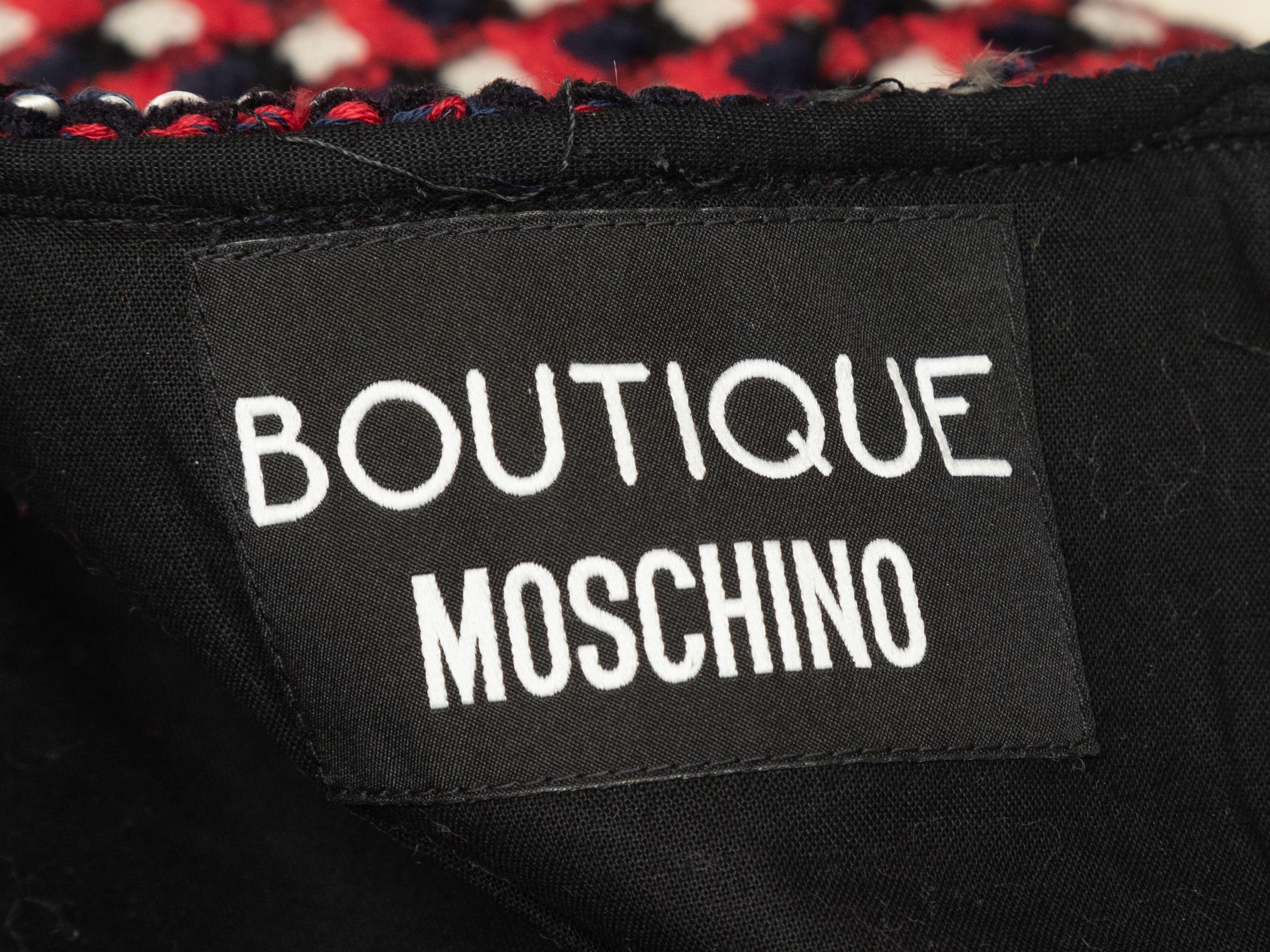 Product Details: Red and multicolor tweed short sleeve dress by Boutique Moschino. Crew neckline. Zip closure at back. 33