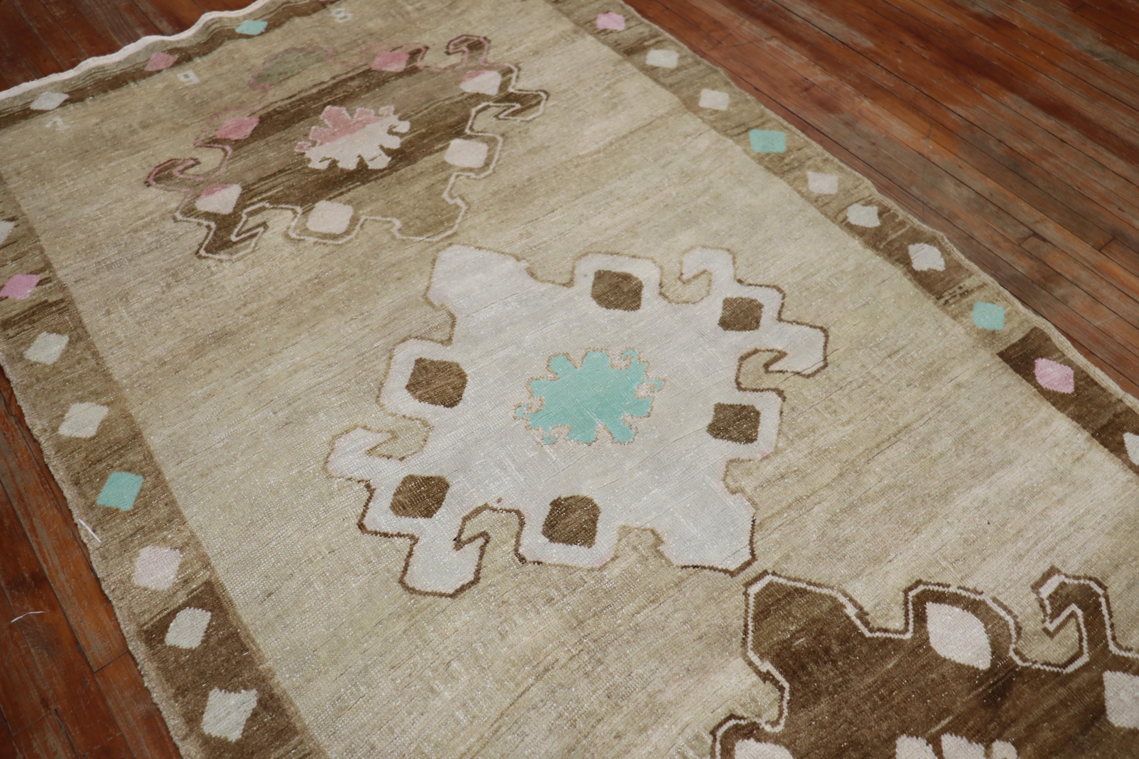 A one of a kind boutique-looking hand-knotted vintage Turkish Kars rug featuring earthy cotton accents in turquoise and pink on a striated brown field covered by 3 large geometric medallions in dark brown and ivory. The accent colors were handwoven