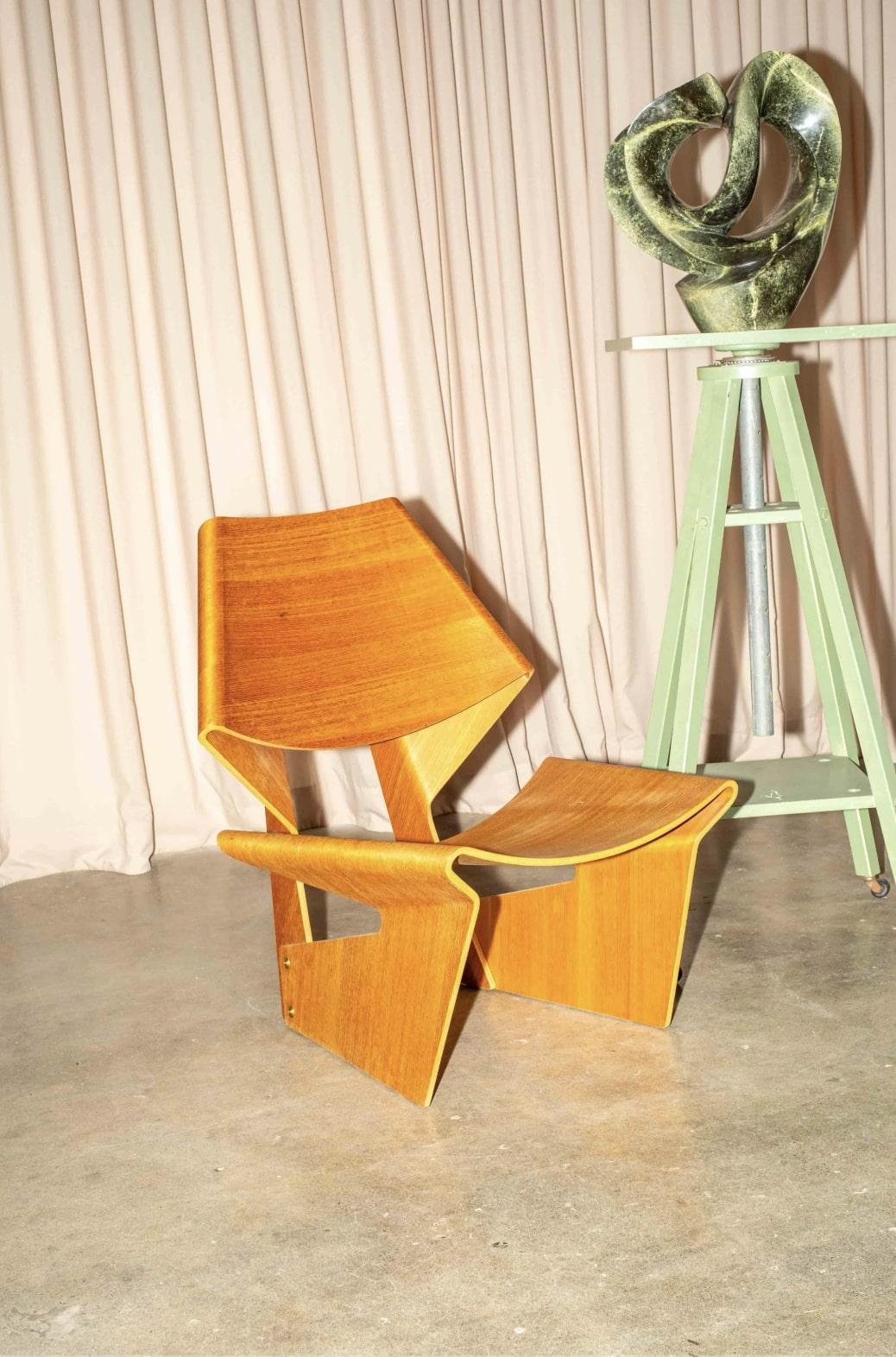 The best known work by Danish designer Grete Jalk (1920 – 2006), the GJ Bow Chair made its debut in 1963. Constructed of two pieces of molded plywood, a material designers had been experimenting with since the 1930s, this piece has an organic