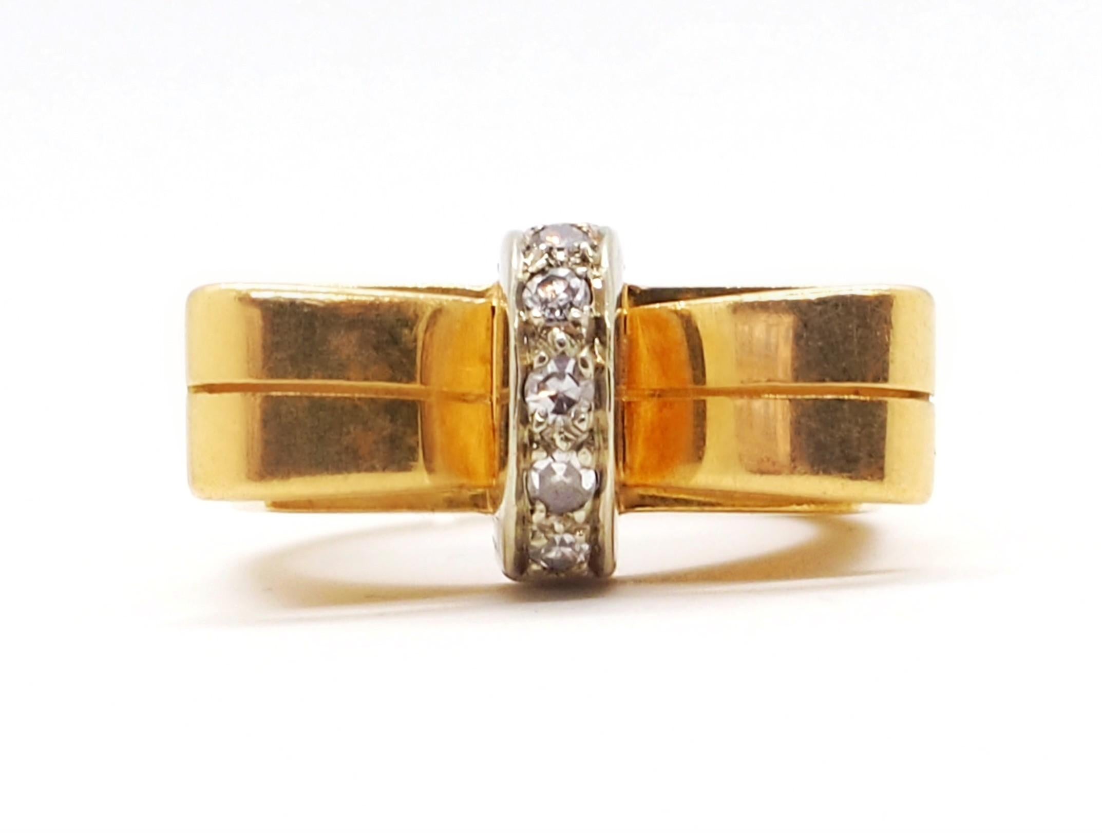 An elegant diamond ring crafted in 18 K yellow and white gold. The superior part of the ring is represented by a bow with a white gold center which is paved with 5 diamonds (0.25 carat).

Total weight: 9.5 grams
EU size: 44
US size: 3

The Ring can