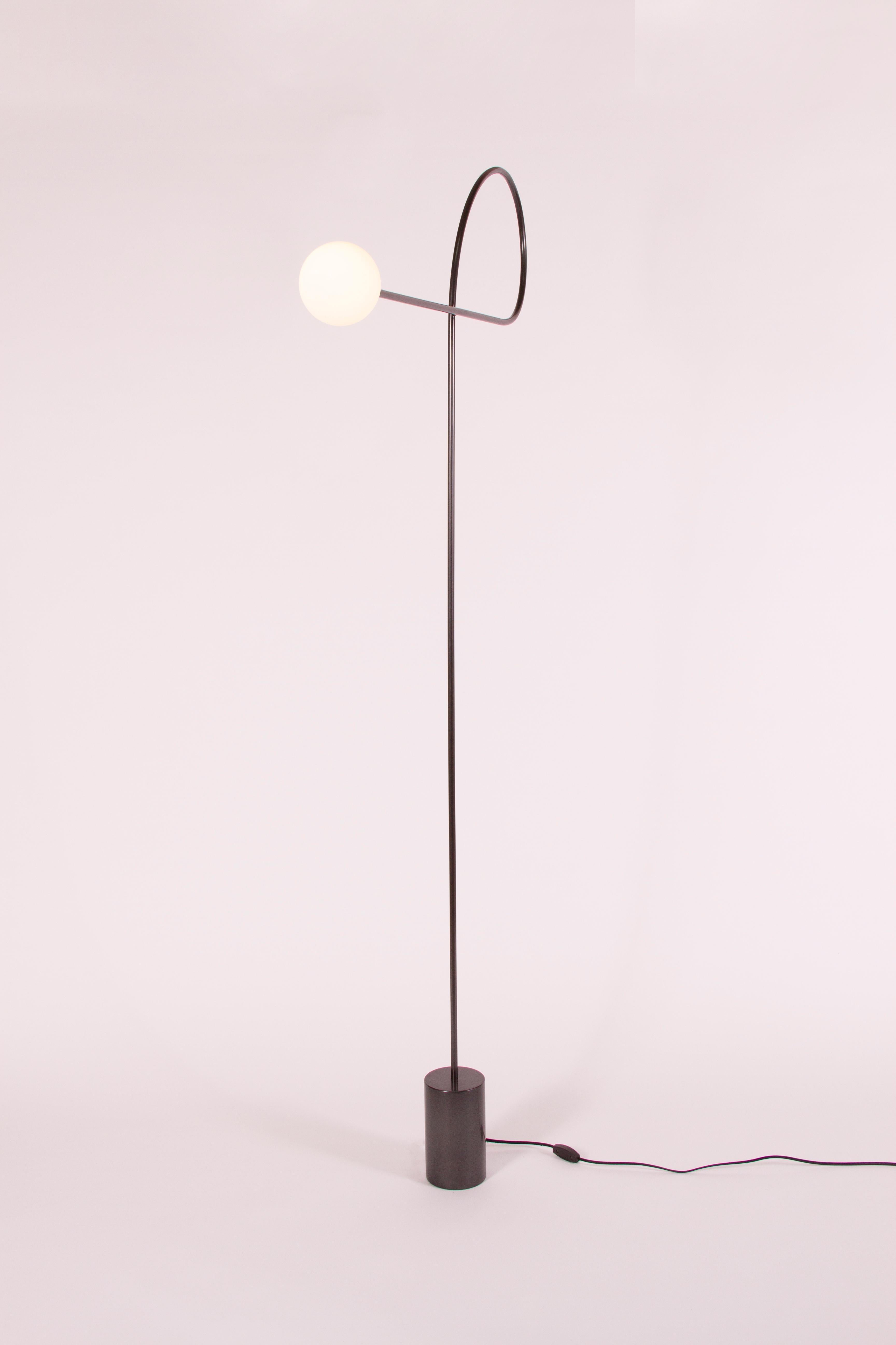 Bow floor lamp by Estudio Persona
Dimensions: W 99 x D 10.2 x H 185.5 cm
Materials: Steel, hand blown glass.

Floor lamp in blackened steel with hand blown glass.
Customizations available.

Estudio Persona was created by Emiliana Gonzalez and
