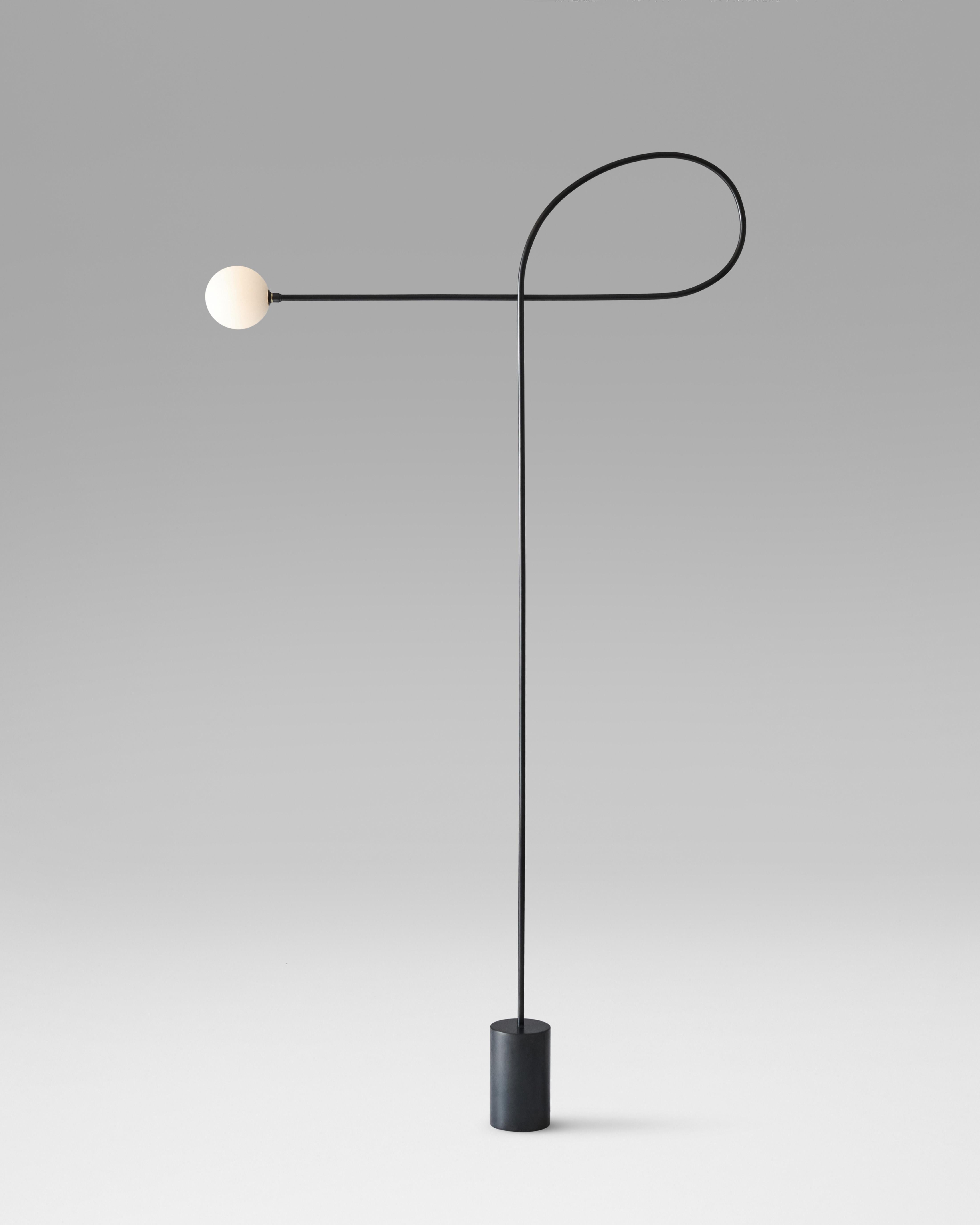 Bow floor lamp made of blackened steel and hand blown glass. Finished with a black, fabric-covered electrical cord. An LED bulb creates a soft, even glow.

Materials: Steel, hand blown glass

This item is designed and handmade to order in Los