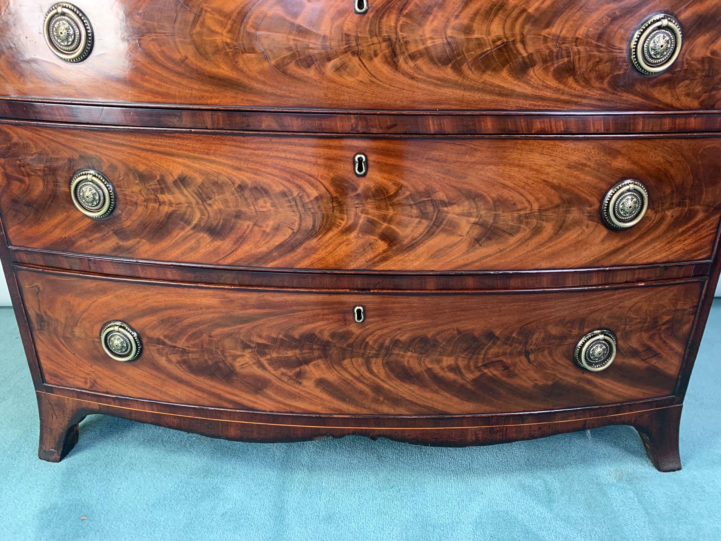 A superior quality George III period flame figured mahogany chest of four graduated drawers of exceptional colour and beautifully figured surfaces. Standing on splayed feet with shaped apron between. Drawer are lined in cedarwood and the locks and