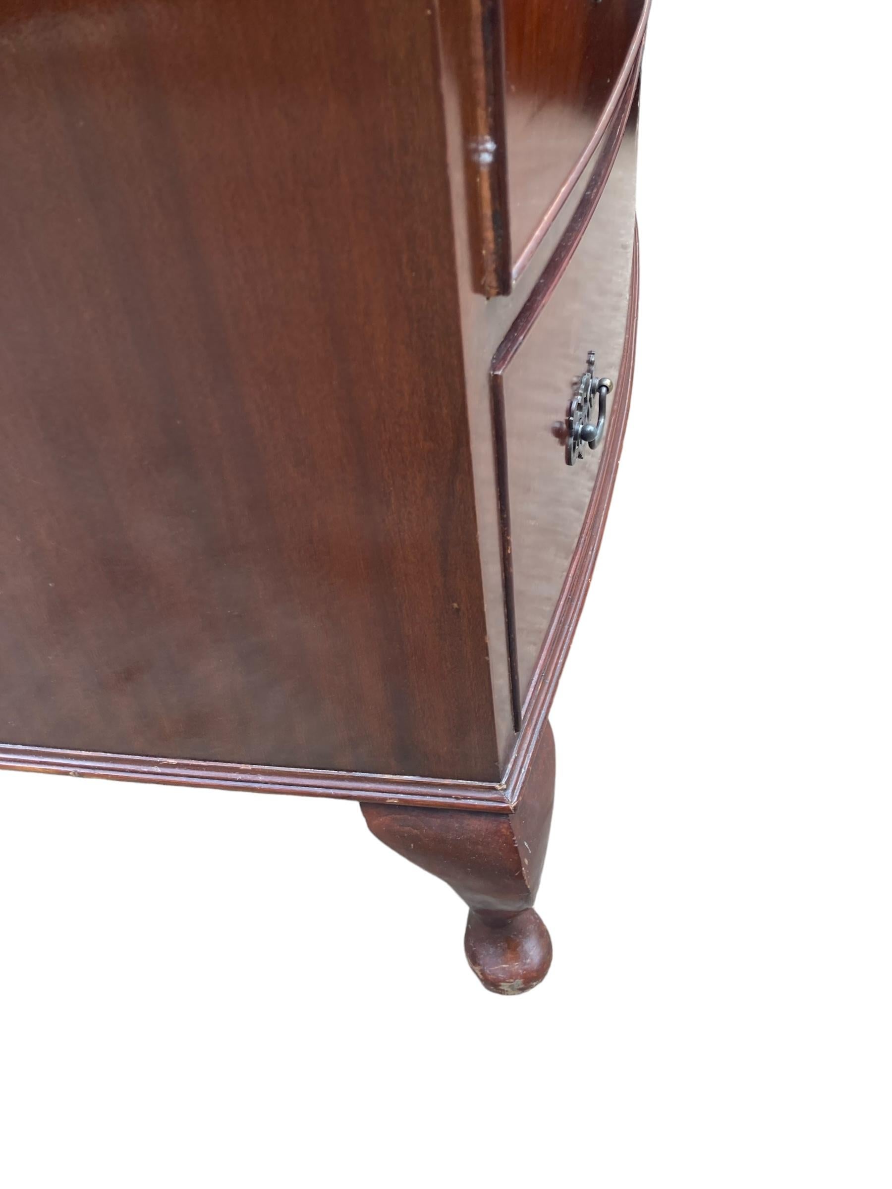 Bow fronted Mahogany Chest of 4 graduated drawers, each fitted with two decorative brass drop handles with brass escutcheon. The antique mahogany chest of drawers is raised on splayed bracket feet and a shaped apron. Beautiful colour and patina.