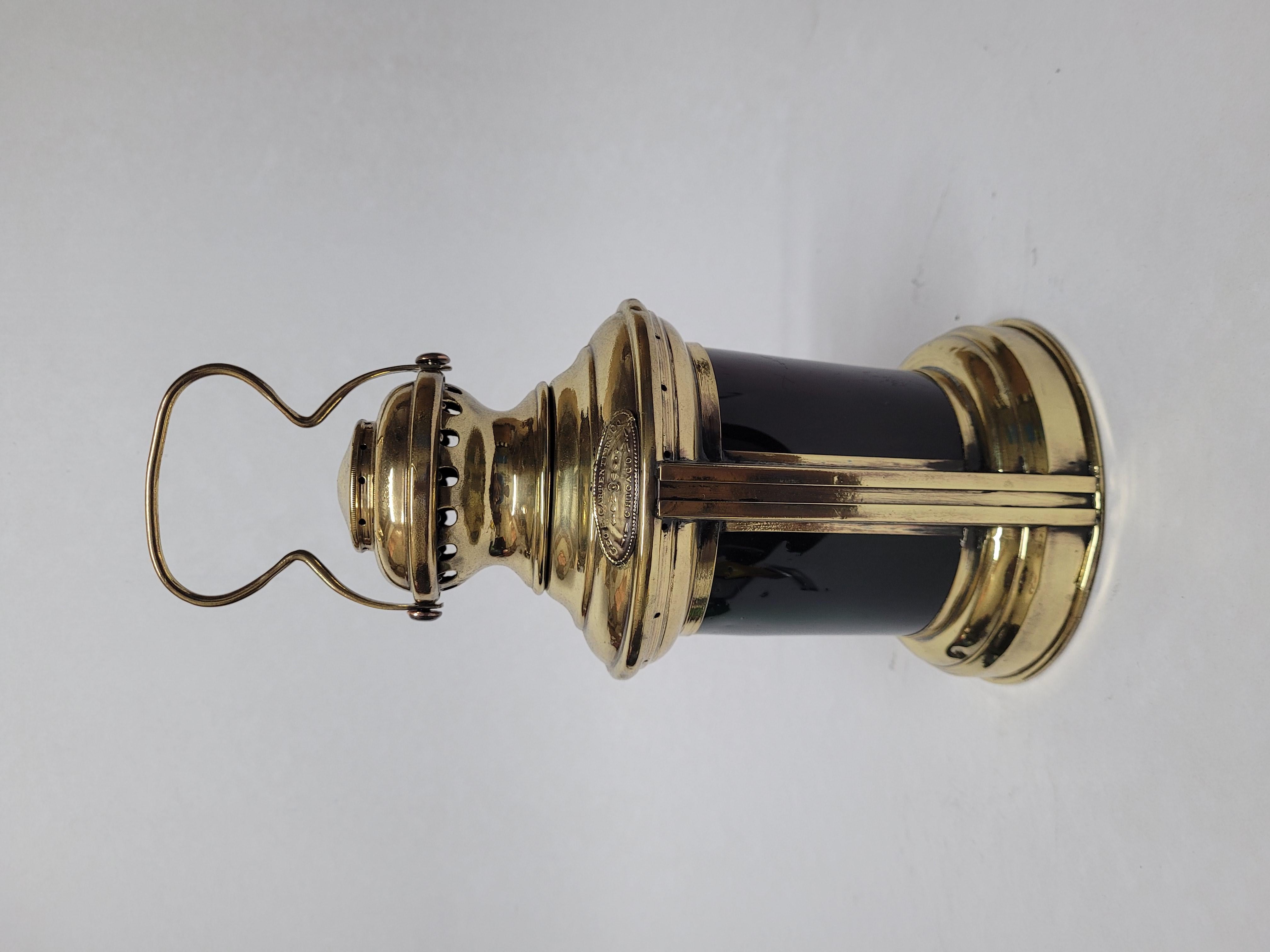 Port and starboard solid brass boat lantern from George Carpenter of Chicago. Curved red and green lenses. With original burner. Meticulously polished and lacqured. Several very small use related dings. Fine nautical antique American. Circa