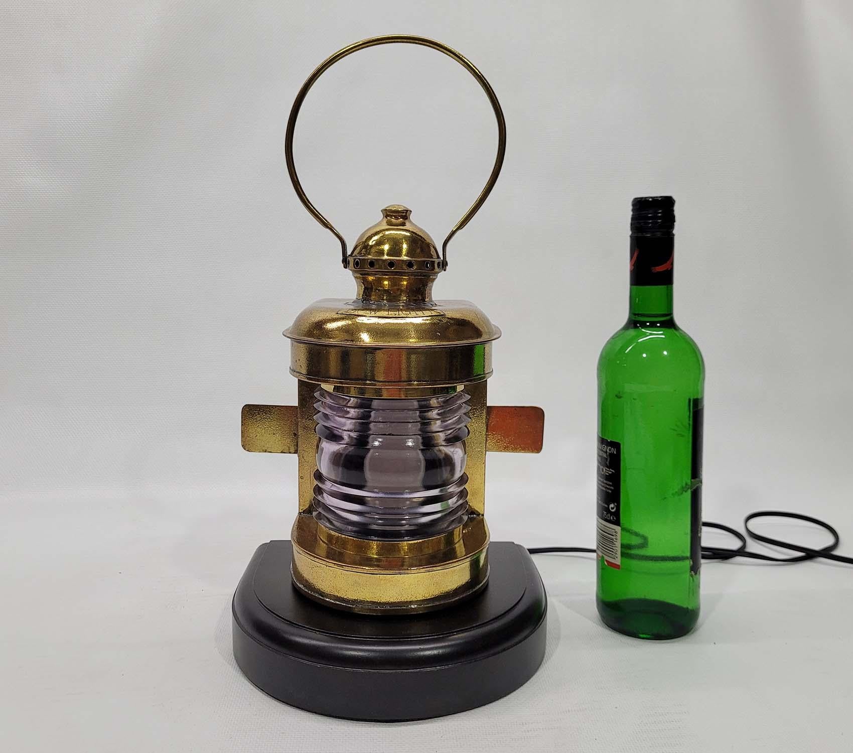 Solid brass masthead lantern with lavender tinted Fresnel lens. Vented top with carry ring. “Bow light” is engraved onto an applied badge soldered to the case. Rewired with electric socket. Mounted to a thick wood base. Circa 1920

Weight: 5