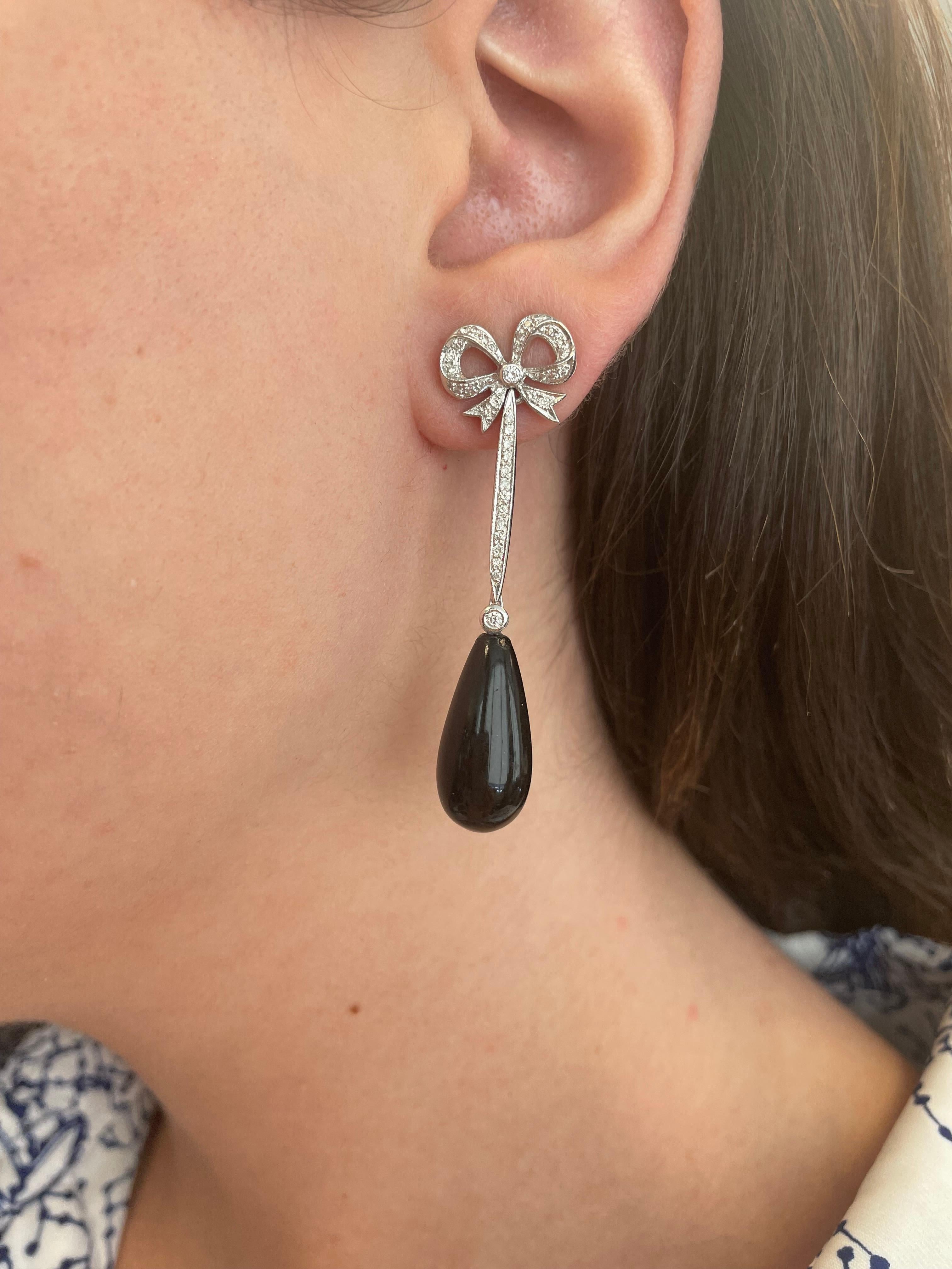 Lovely bow motif diamond bow with beaded onyx earrings.
78 round brilliant diamonds, 0.57 carats, approximately G/H color grade and SI clarity grade diamonds. 2 beaded onyx, 18-karat white gold.
Accommodated with an up to date appraisal by a GIA