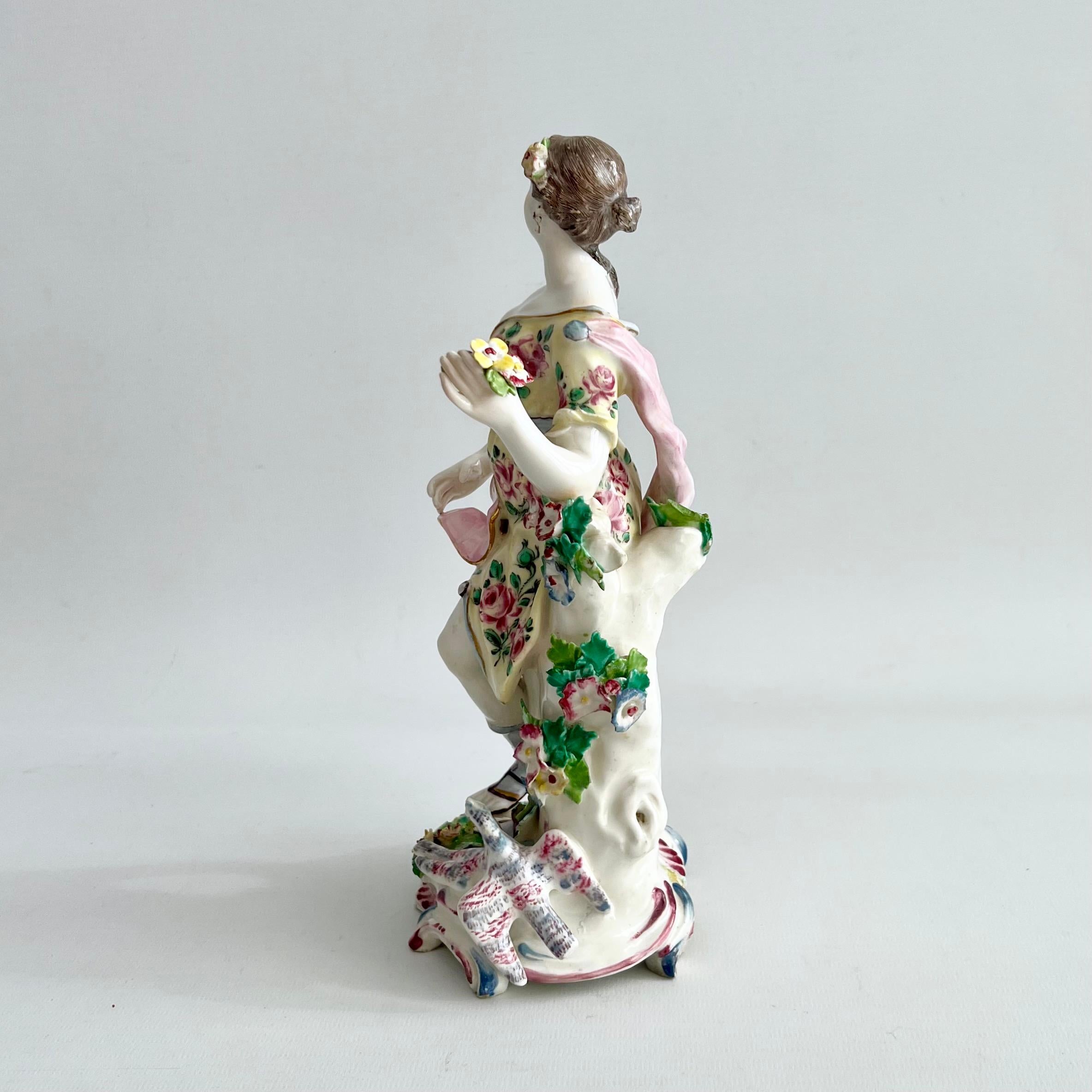 This is a rare and beautiful figure of Venus with two doves, made by the bow porcelain factory between 1756 and 1764. We see Venus standing holding her robe with one hand, a flower posy in the other hand. One of her breasts is delicately exposed. At