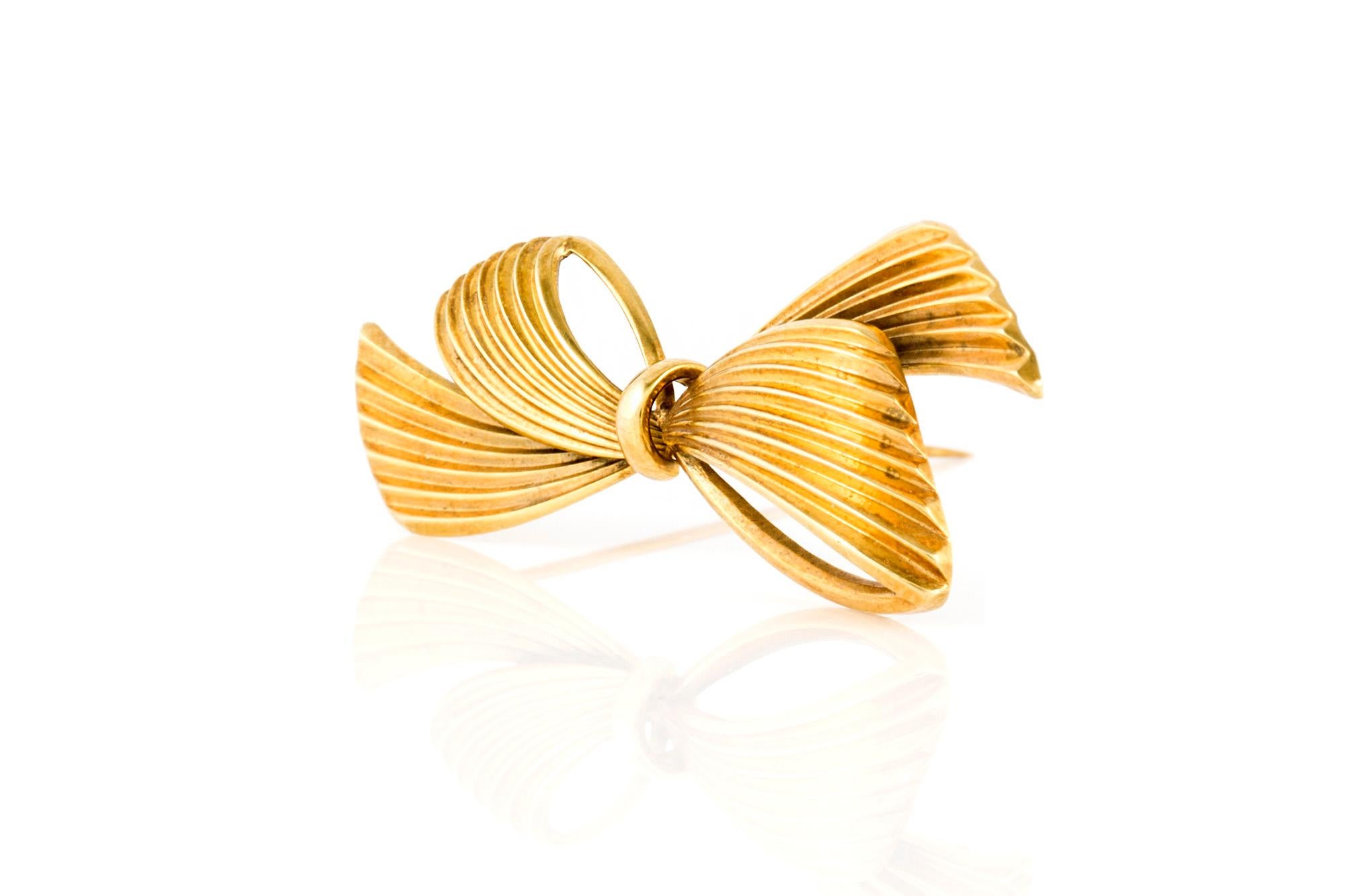 The brooch is finely crafted in 14k yellow gold and weighing approximately total of 4.00 dwt.

Sign by Tiffany & Co
