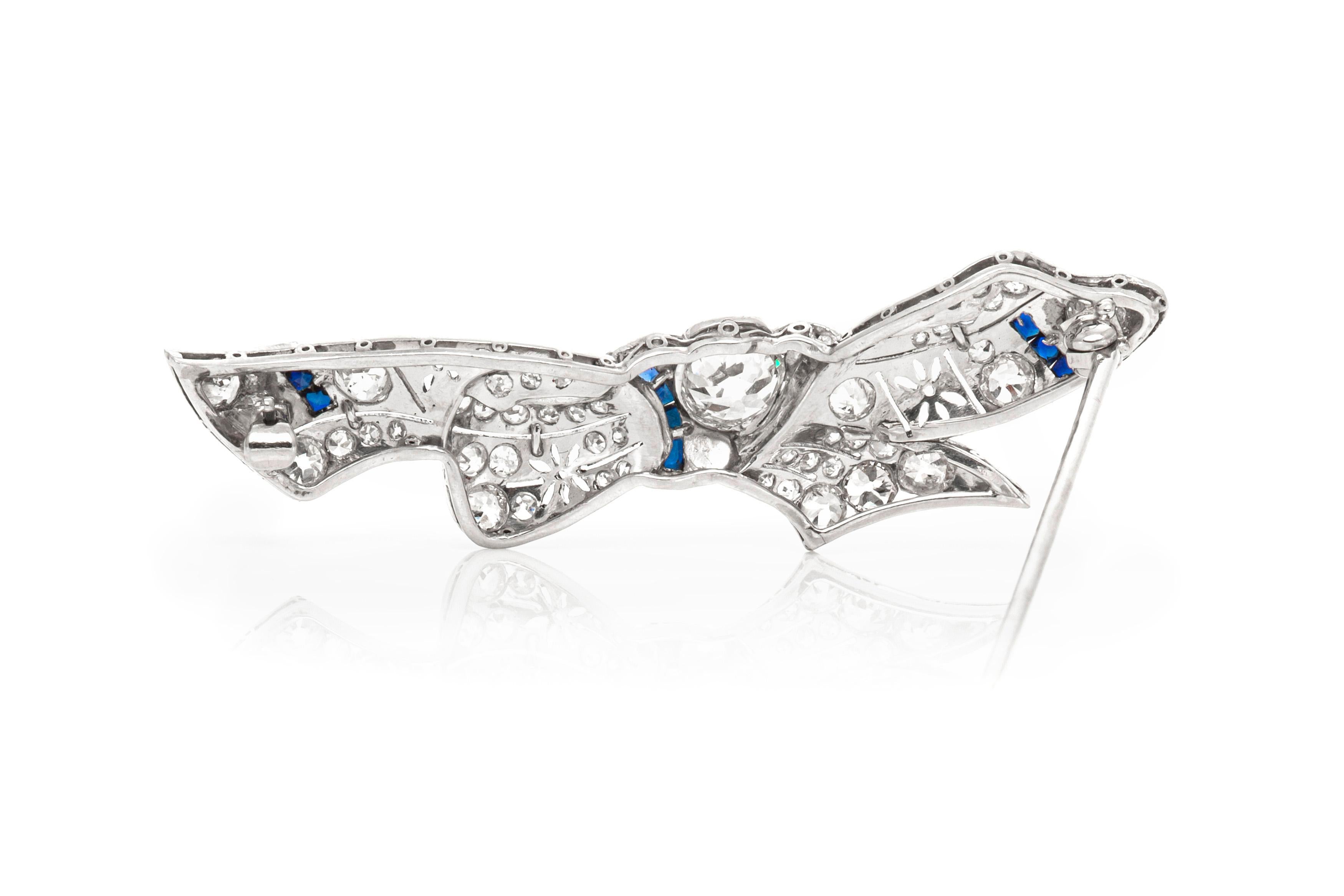 The brooch is finely crafted in platinum with diamonds weighing approximately total of 6.00 carat and synthetic sapphire.