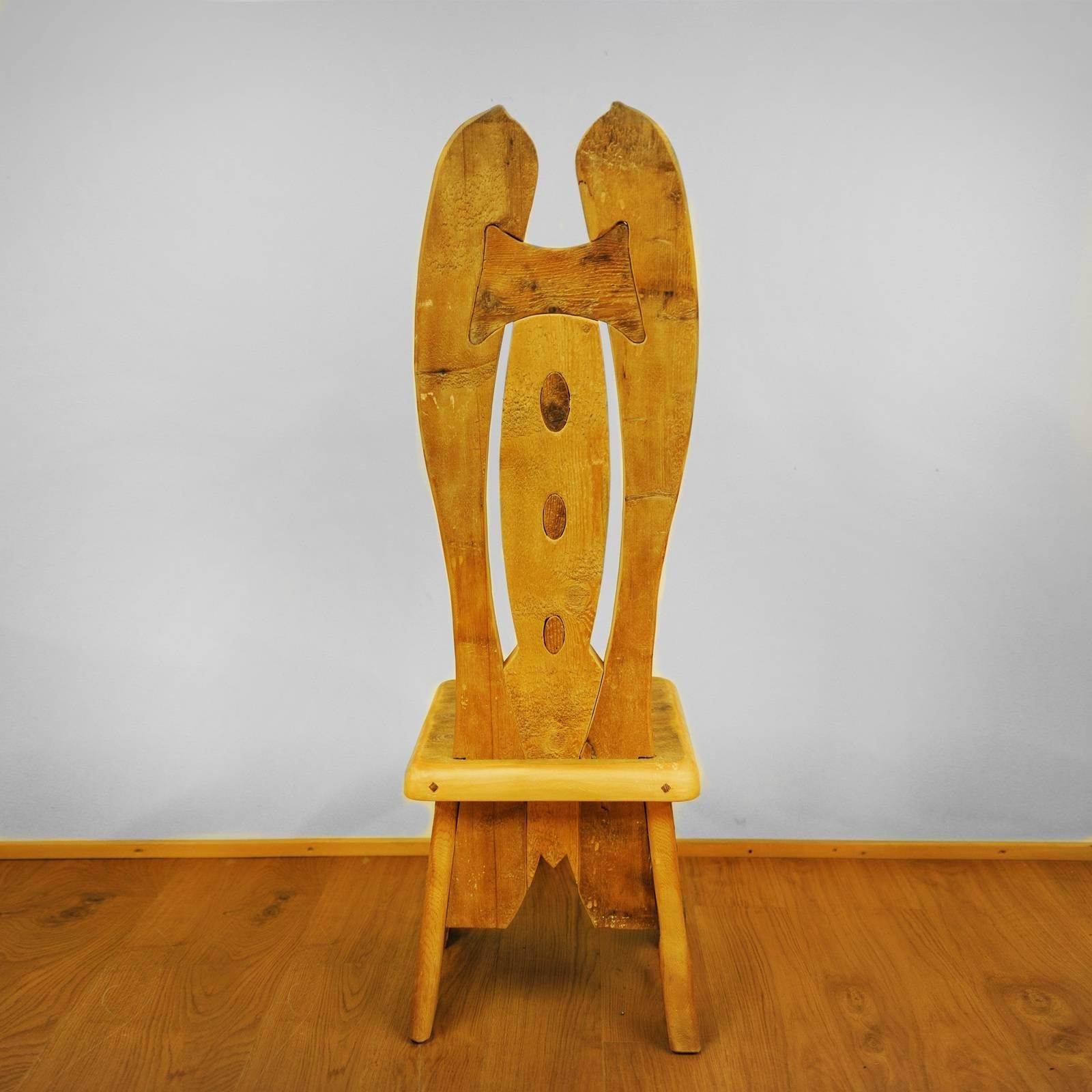 Playfully reminiscent of a bowtie topping a button-down shirt, the decoration gracing the backrest of this chair was crafted using Swiss pine, pine, larch, and fir coming from 16th century old floors. The on-of-a-kind effect is striking and creates