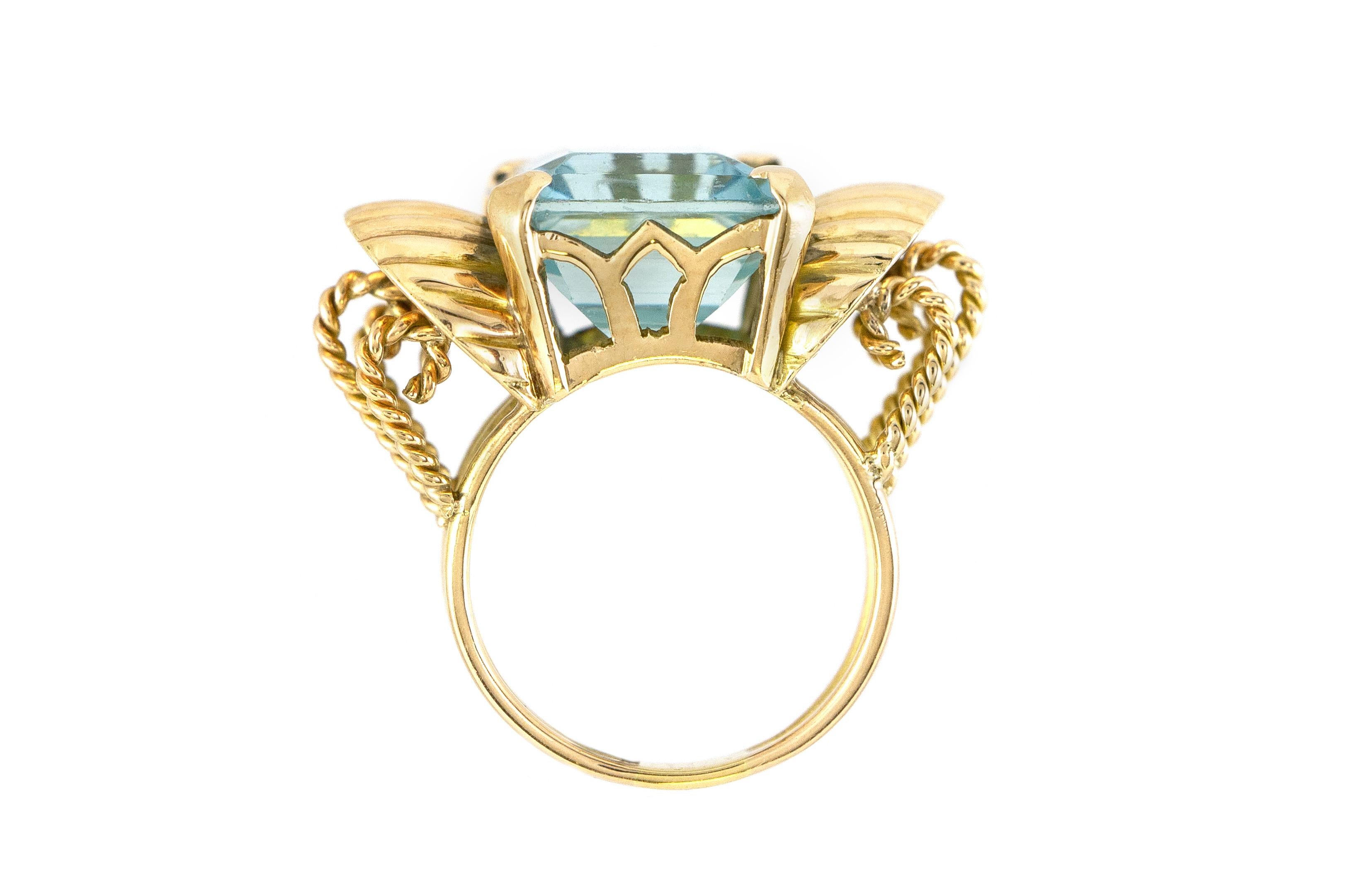 The ring is finely crafted in 18k yellow gold with center stone aquamarine weighing approximately total of 12.00 carat.