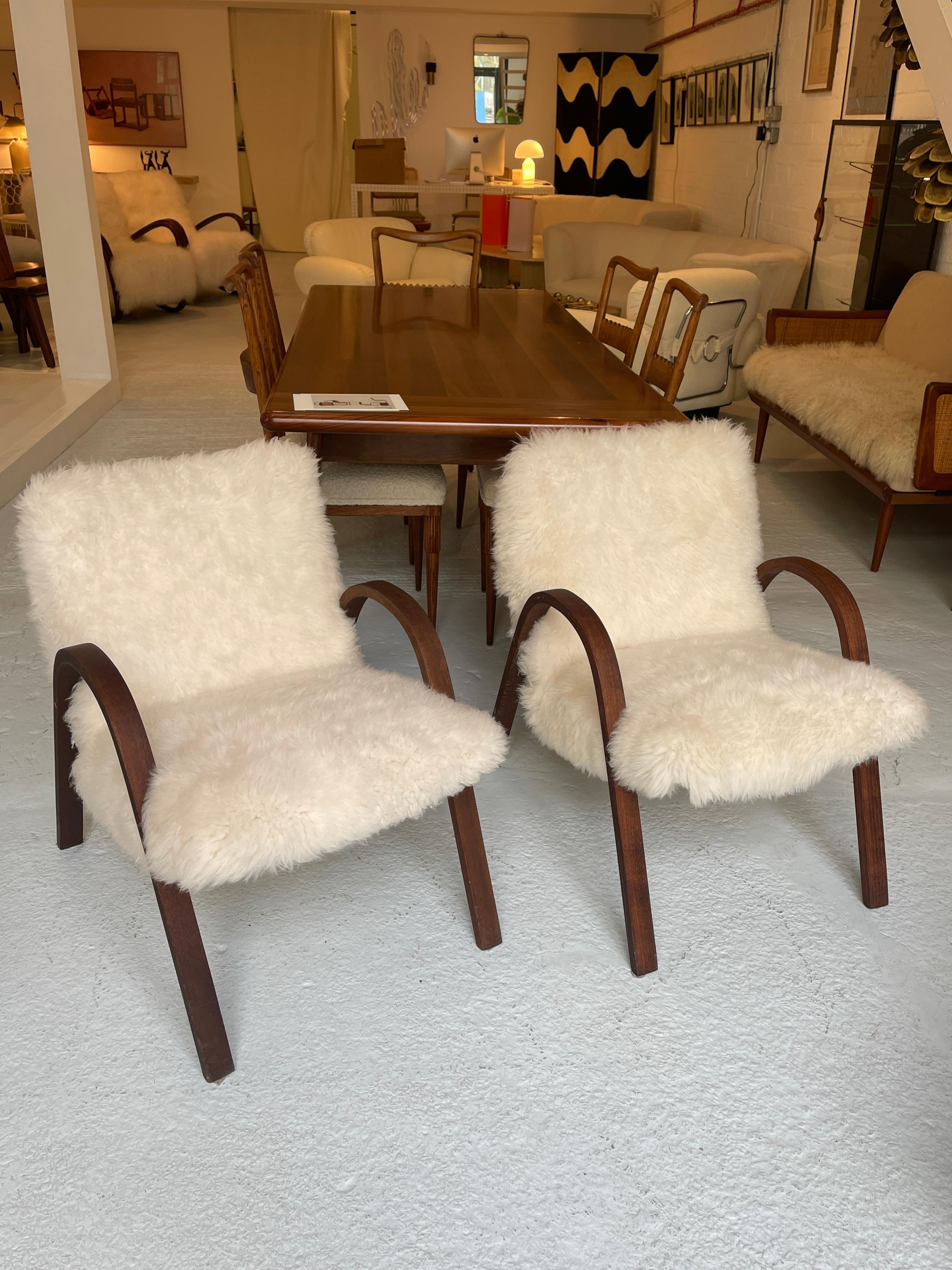 Handmade bow wood chairs with sheepskin upholstery.