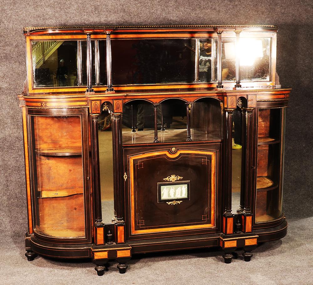 As far as English Victorian era credenzas go, this one is very unique. This one has a super-structure top with mirror- something very few of these have. A quick perusal on more expensive sites online will quickly reveal that these often bring