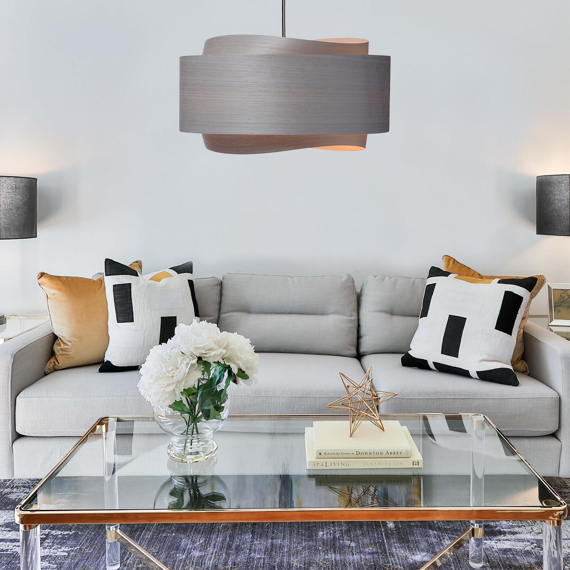 The BOWEN light fixture is a stunning example of contemporary Mid-Century Modern design. With its minimalist silhouette, beautifully translucent gray tones, and unique shape, this pendant light is sure to add a touch of sophistication to any