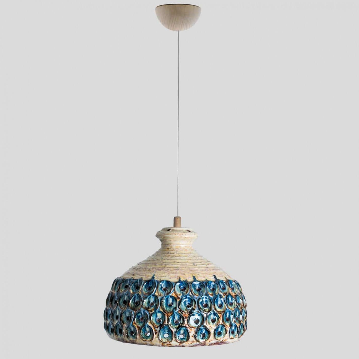 Stunning small round hanging lamp with a bowl-like shape, made with rich blue creme colored ceramics, manufactured in the 1970s in Denmark. We also have a multitude of unique colored ceramic light sets and arrangements, all available in the front