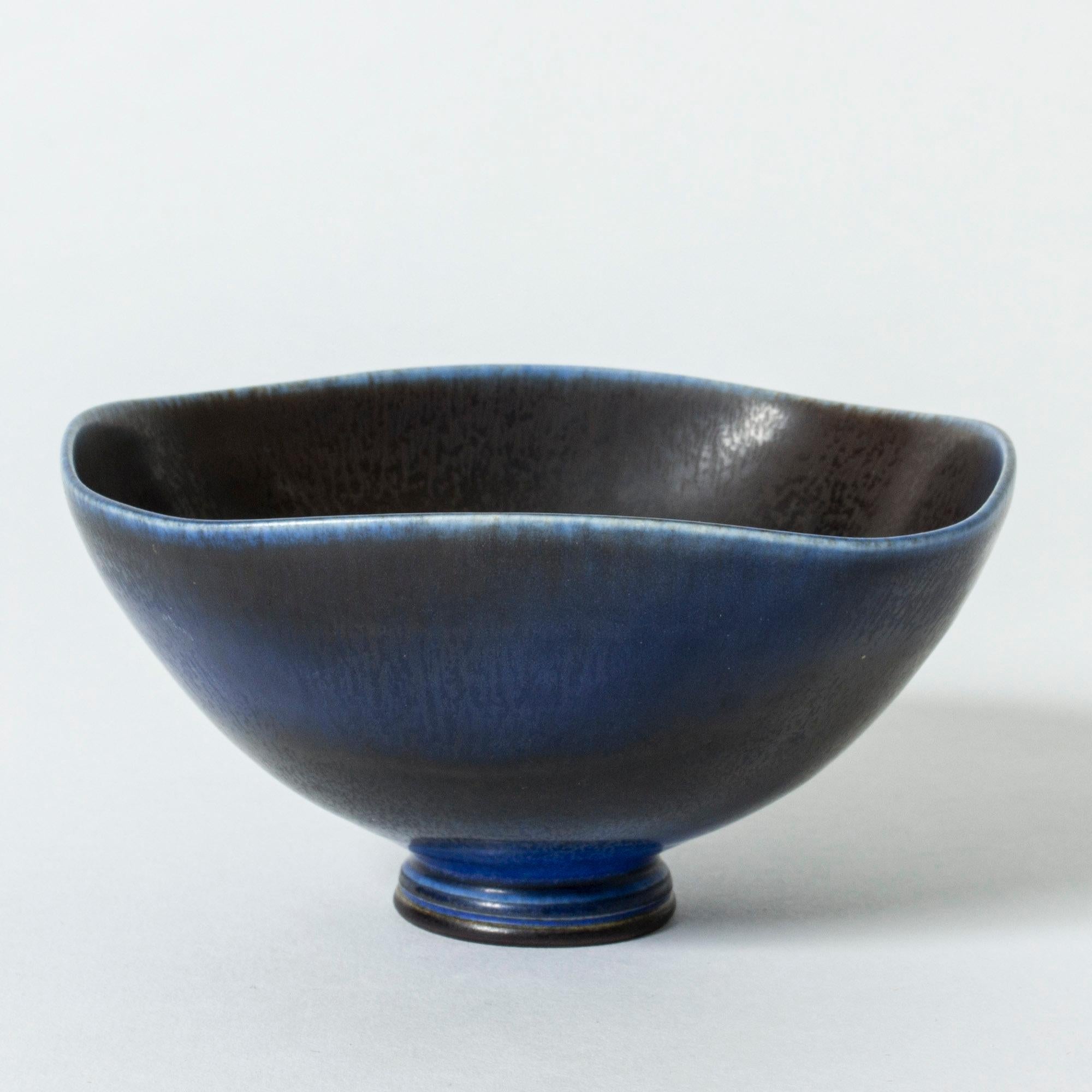 Beautiful stoneware bowl by Berndt Friberg. Slightly square form with rounded corners, undulating edge. Elegant blue hare’s fur glaze.

Berndt Friberg was a Swedish ceramicist, renowned for his stoneware vases and vessels for Gustavsberg. His