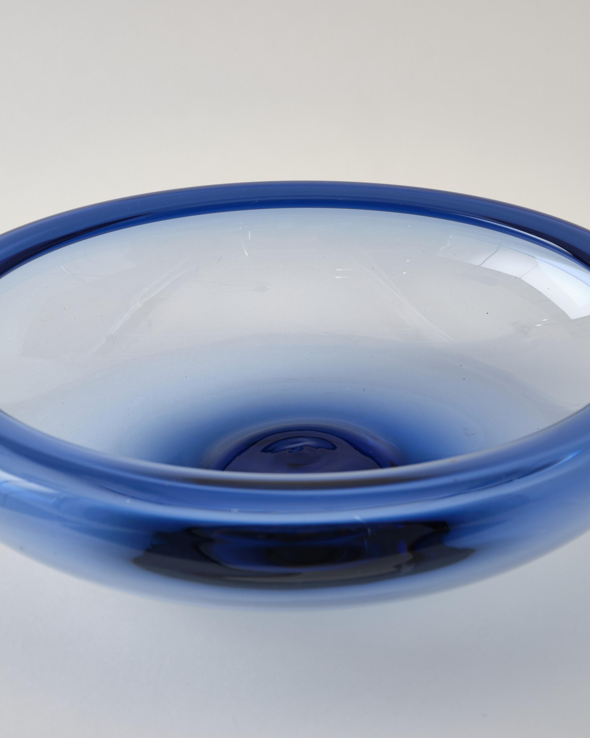 Large, beautiful glass bowl by Holmegaard, Denmark, C 1960. The item is signed. It was produced in the 1960's. It is in very good condition.
Glass is light color blue and the shape is a round large bowl.