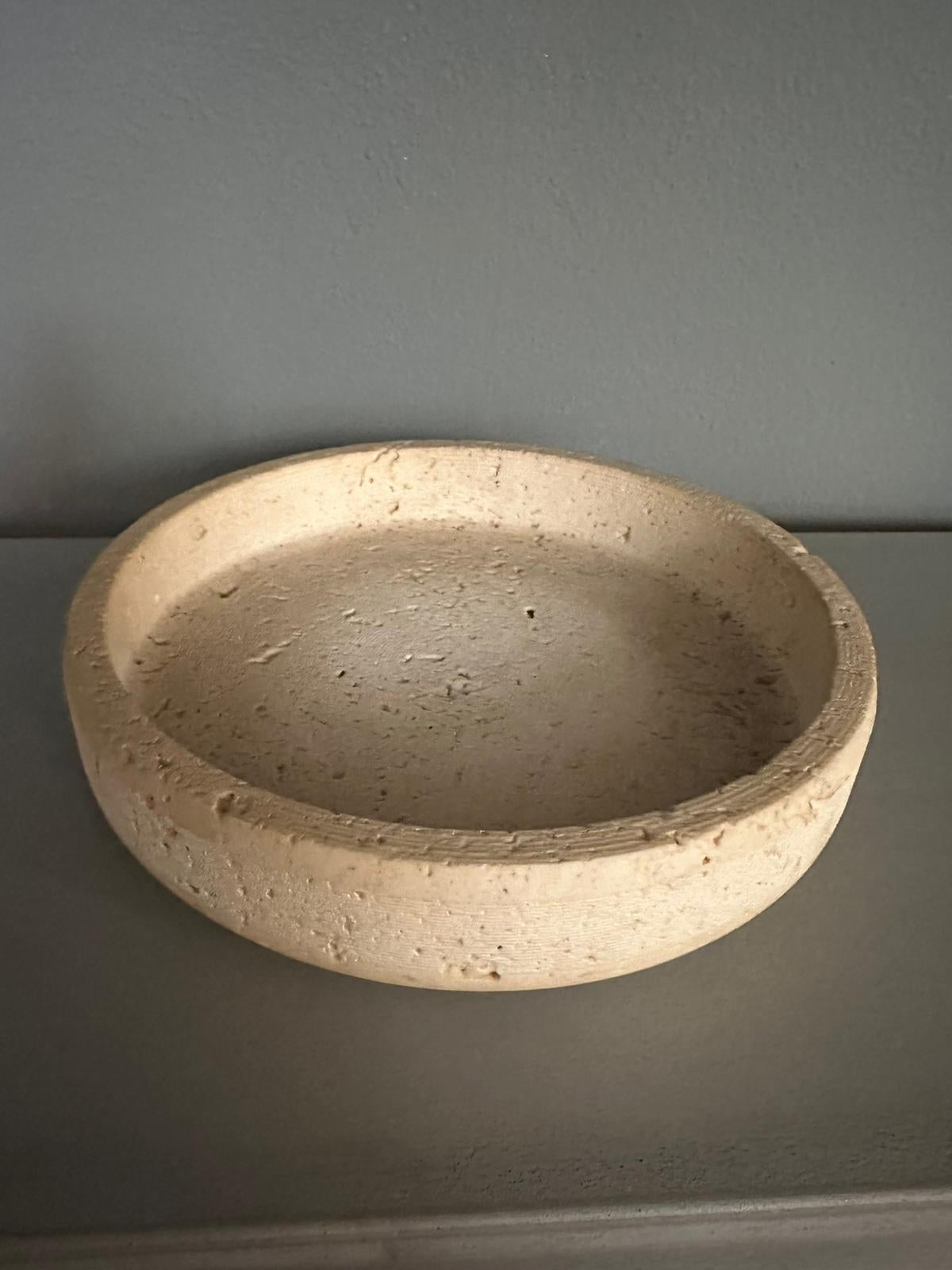 Travertine marble centerpiece designed by Egidio Di Giusti for Up & Up in 1970. Travertine marble centerpiece with a 20diameter of about cm. The marble shows all its material making the centerpiece elegant.