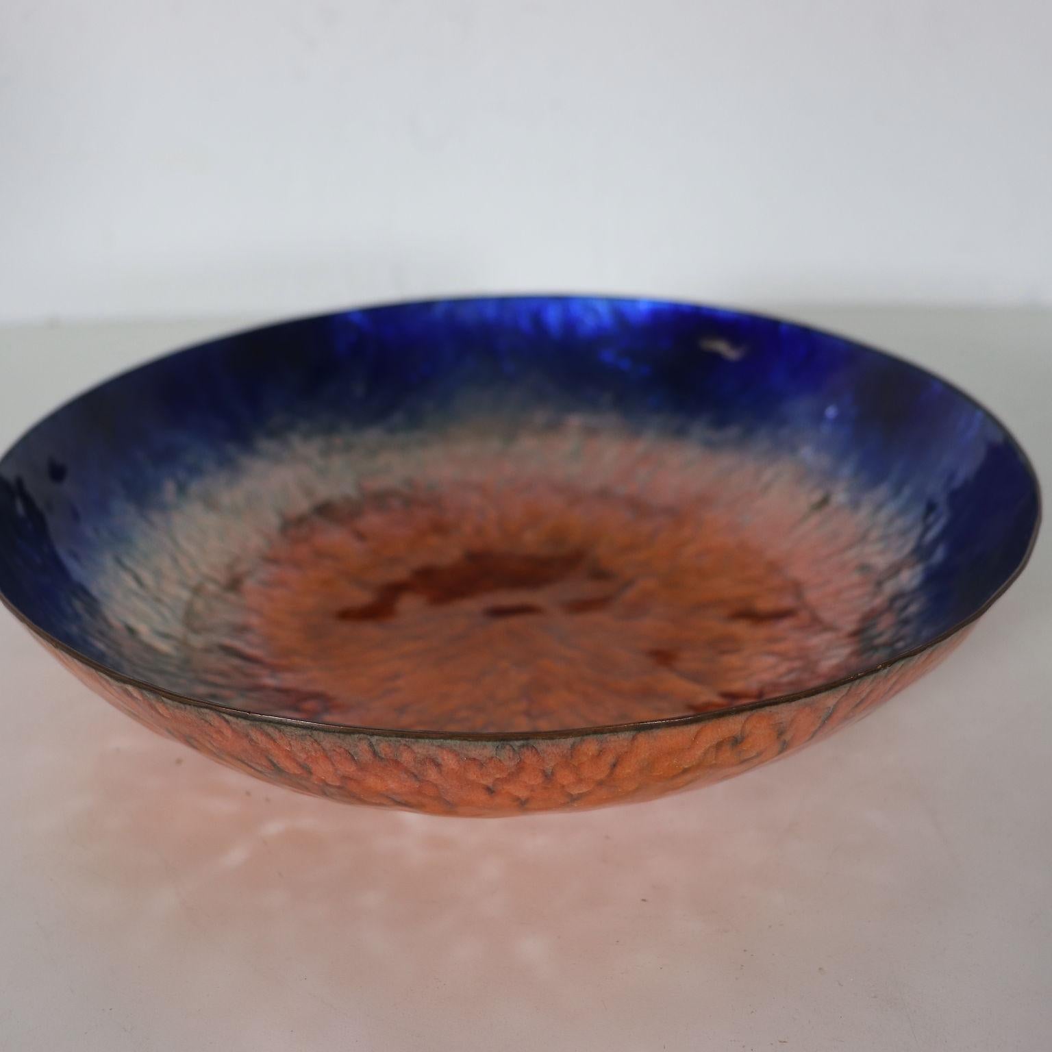 Hammered copper bowl enameled on fire. Internal part polychrome enameled. Author's signature under the base.