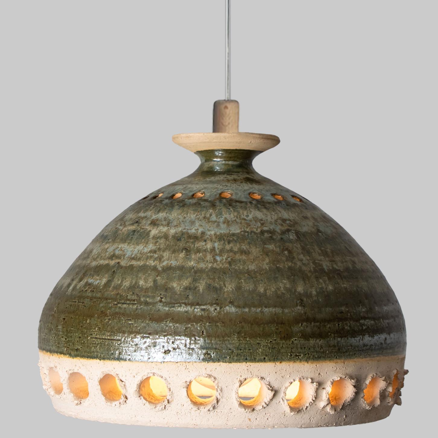 Stunning round hanging lamp with an unusual shape, made with rich green colored ceramics, manufactured in the 1970s in Denmark. We also have a multitude of unique colored ceramic light sets and arrangements, all available on the frontstore.