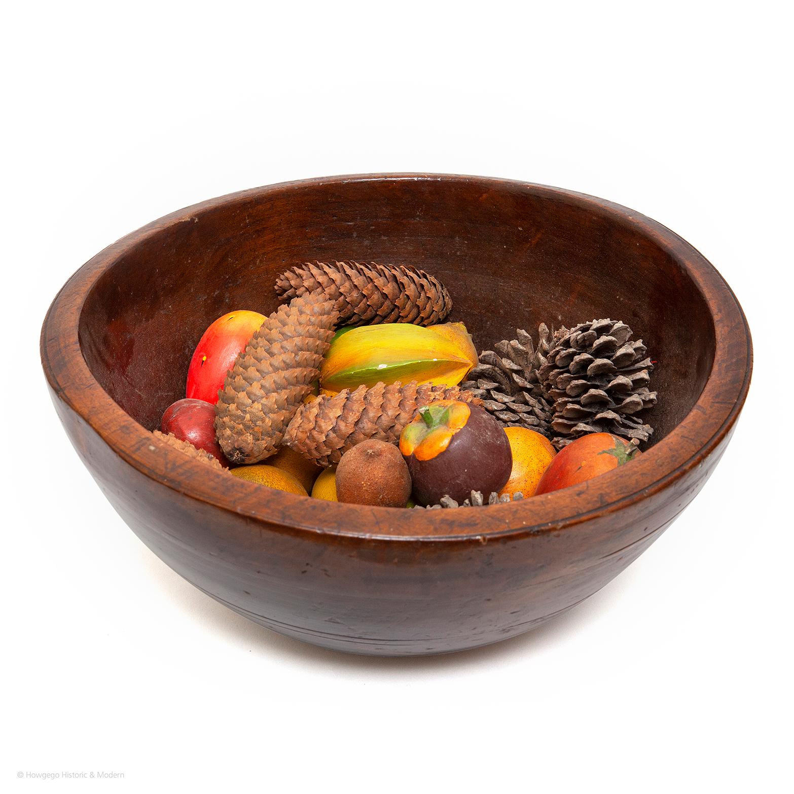 An exceptional, large 18th century treen turned fruitwood dairy bowl with a rich lustrous patina

Provenance: Collection of the late Geoffrey Harley, Pickwick End, Corsham

The fourteen pieces of 19th century wooden painted fruit can be