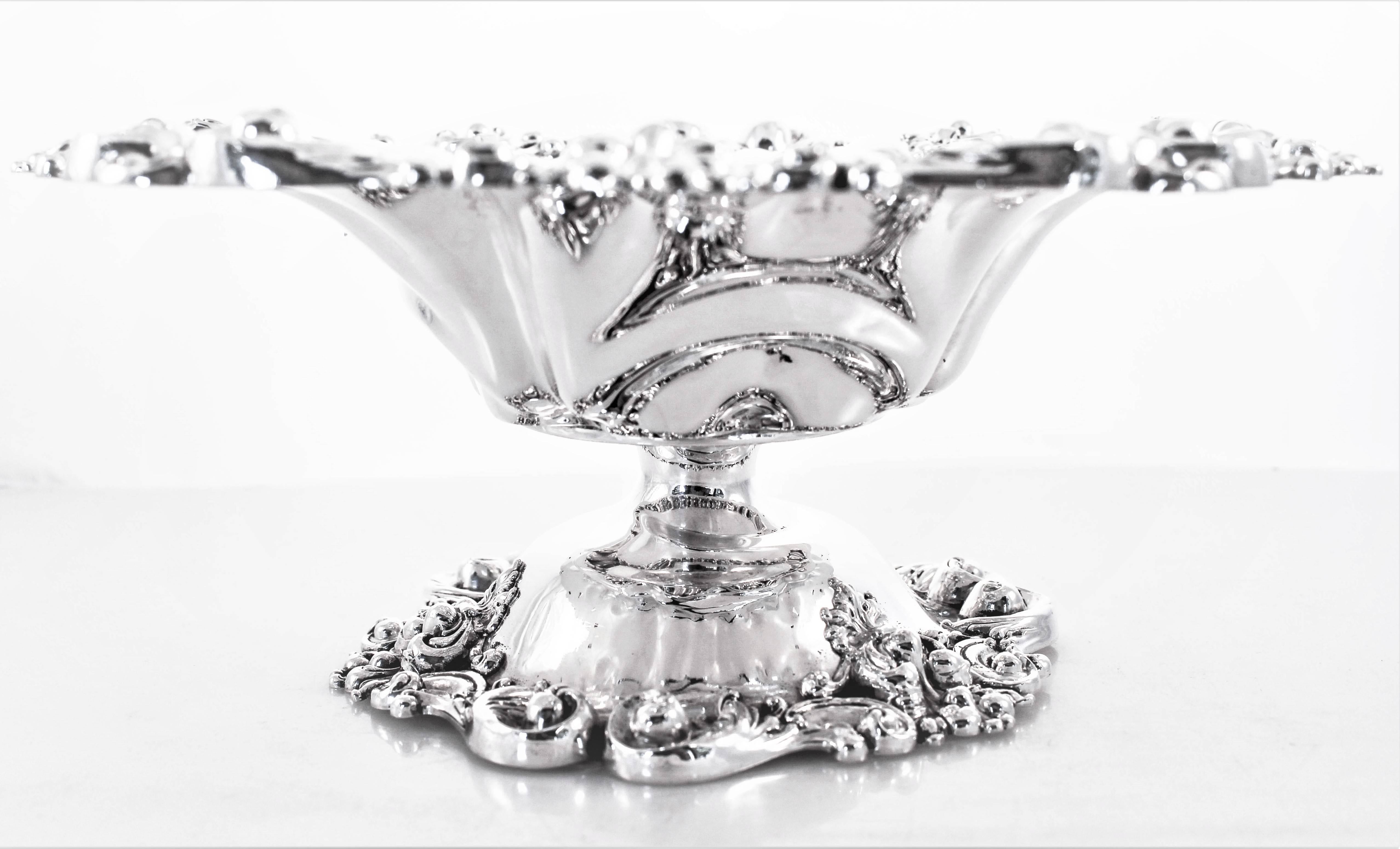 Heavy, intricate work can be found both around the top and base. A scalloped top and base with pierced work. In the centre a hand engraved monogram in a beautiful script to compliment the ornate exterior. Filled with grapes or and other fruit, this