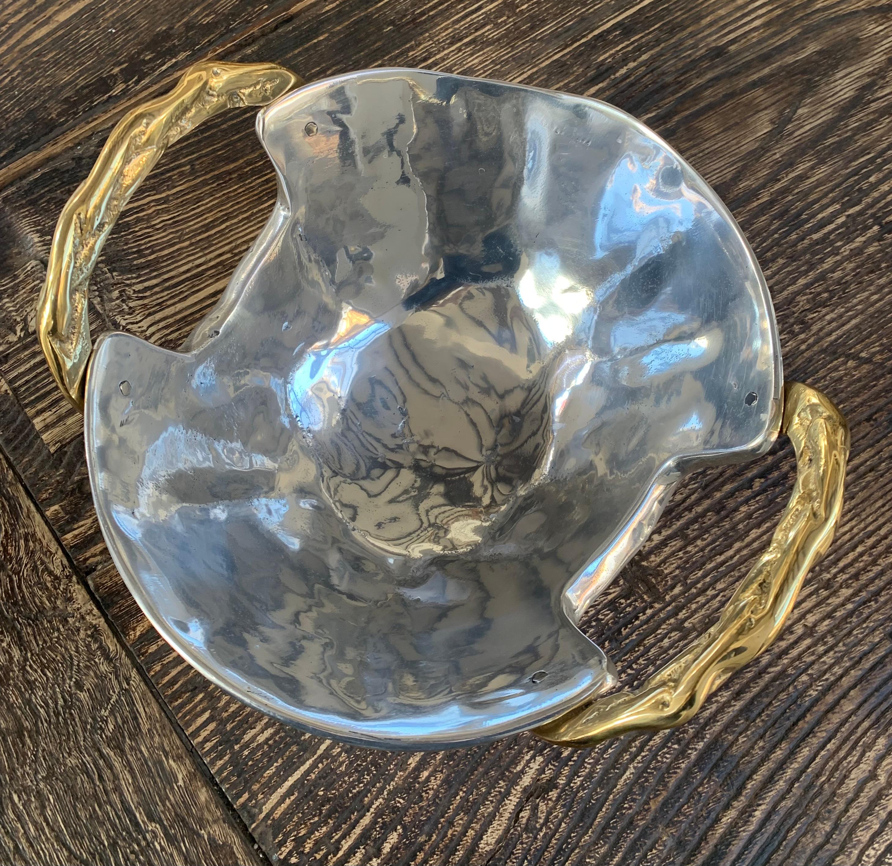 The decorative Bowl  was created by David Marshall, it is made of sand cast aluminum and sand cast brass. 
We can engrave this piece with your Initials or Logo, makes a beautiful Wedding or Company Gift.
Handmade, mounted and finished in our foundry