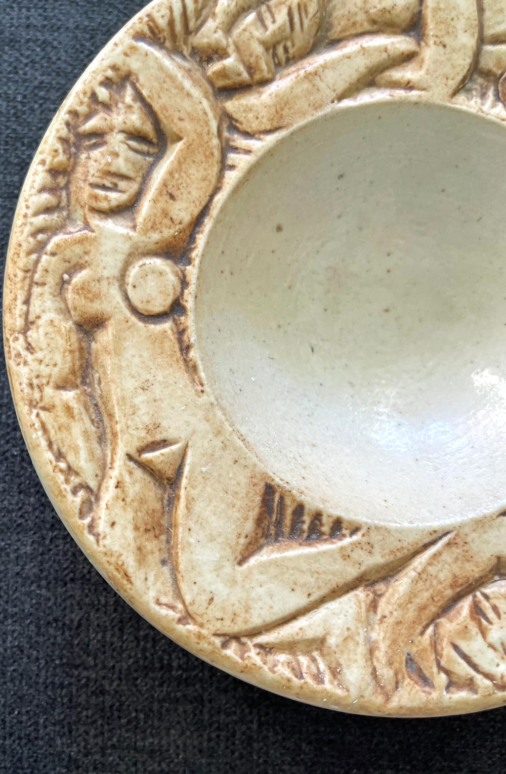 Created by Edouard Cazaux, master sculptor and ceramicist who exemplified the French Art Deco style at its best, this small ceramic bowl is ringed by three, sharply-defined female nudes. Cazaux studied at the Beaux Arts School in Sèvres as a young