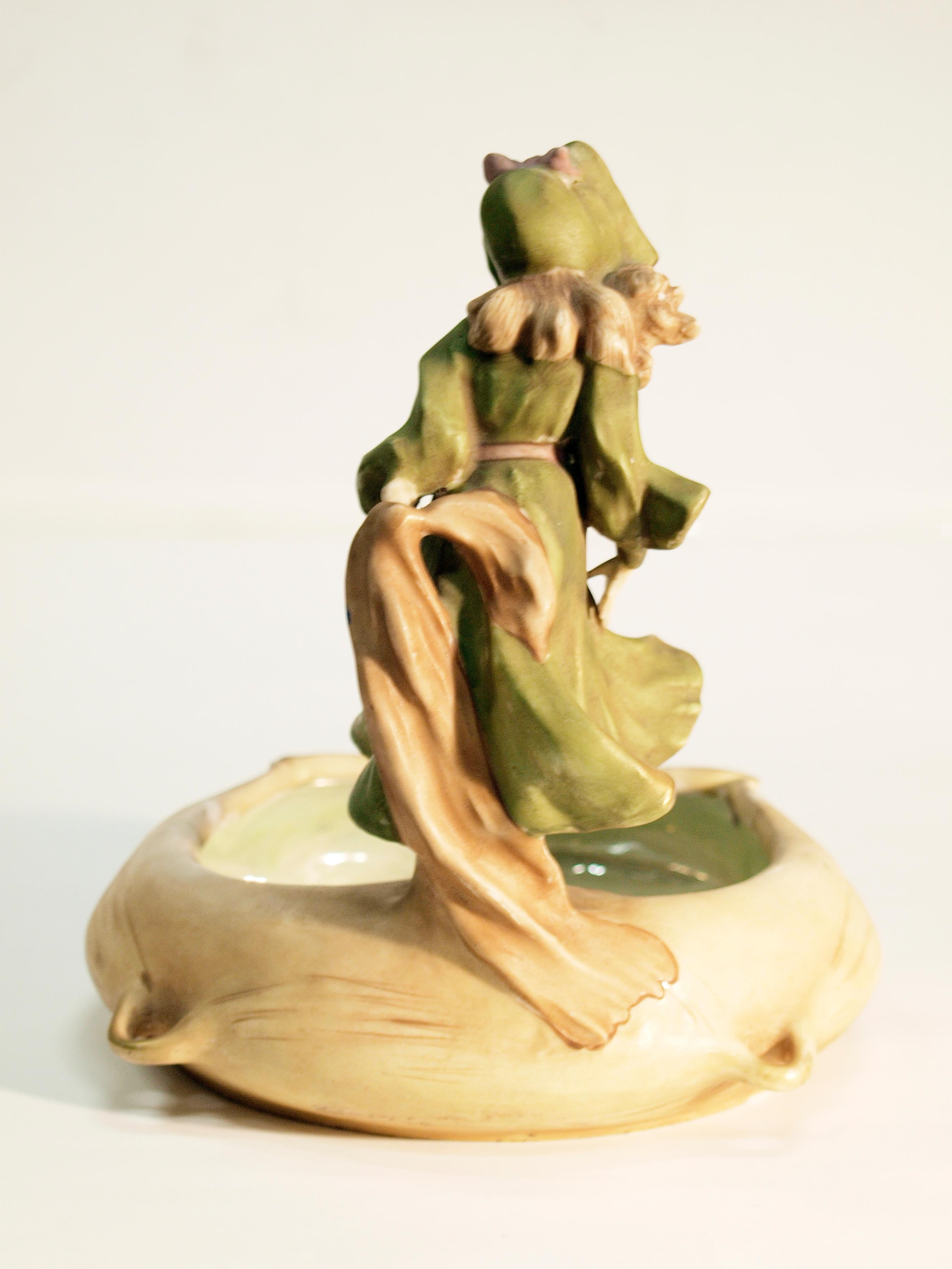 A bowl with a woman on top of it.