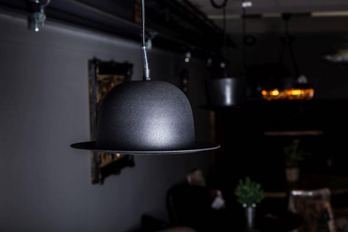 A fine bowler hat pendant light, 20th century.

The perfect statement of British eccentricity, our bowler hat pendant light is sure to bring a smile to anyone's face. It would be a quirky addition to a modern kitchen or home study; alternatively,