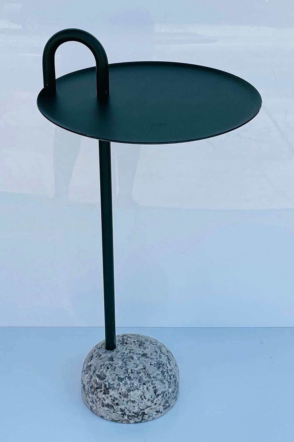 Bowler is a compact side table designed for small spaces.

Its single tube support extends upwards from its solid granite base to create a defined profile and a clever, functional semicircular handle.

The stem, handle, and tray are made from
